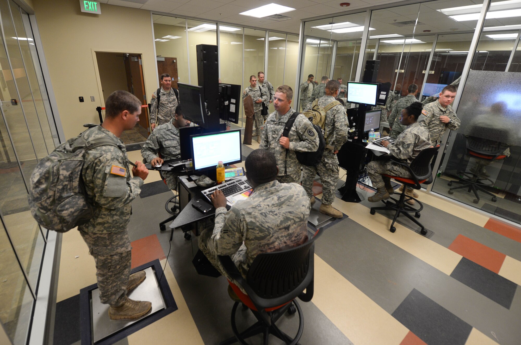 Members of the South Dakota National Guard process through a personnel deployment function Line in the deployment center at Ellsworth Air Force Base, S.D., June 20, 2014 as part of the Golden Coyote exercise. Ellsworth’s deployment center hosts computer-based filing systems for Airmen managing the deployment processing line to enter, change, and verify deployers’ information allowing for faster and accurate processing. (U.S. Air Force photo by Senior Airman Zachary Hada/Released)