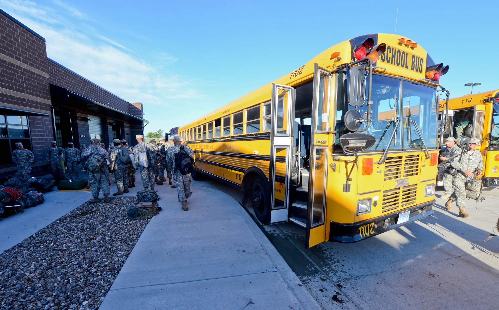 Members of the South Dakota National Guard out-process at the deployment center at Ellsworth Air Force Base, S.D., June 20, 2014 as part of the 30th Golden Coyote exercise. Units from 15 states and three foreign countries participated in the exercise, which allows them to focus on real-world contingency training. (U.S. Air Force photo by Senior Airman Zachary Hada/Released)