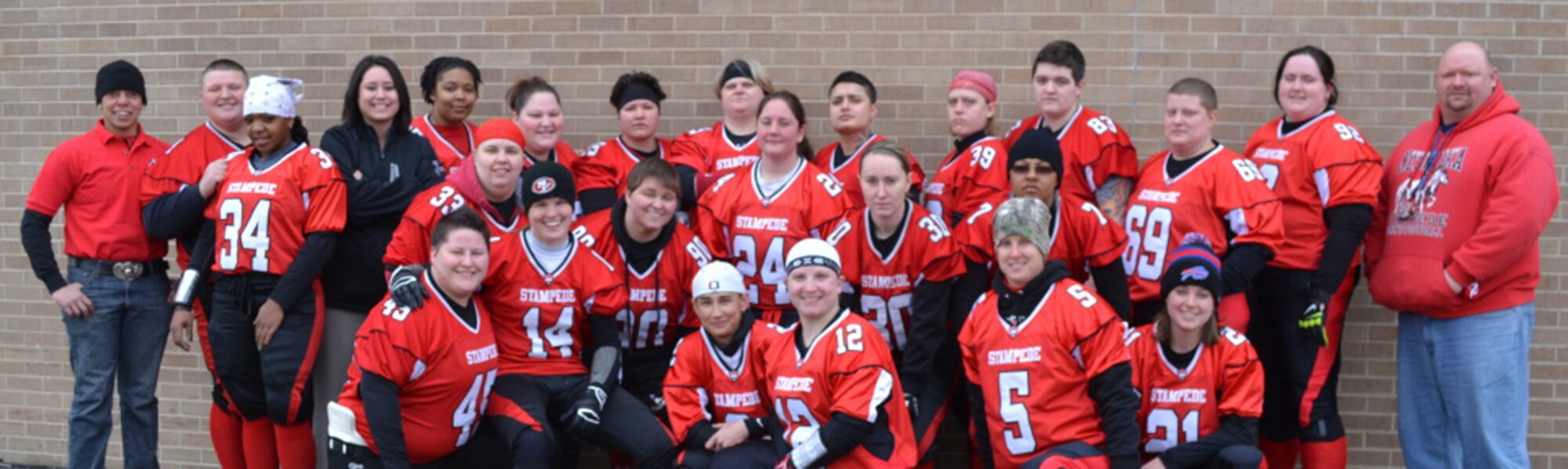 A team photo of the 2014 Nebraska Stampede women’s semi-pro football team. 1st Lt. Delaney Kiernan from the 55th Contracting Squadron at Offutt Air Force Base, Neb. primarily plays safety, but also kicks and plays wide receiver for the team. She is pictured at the bottom right, wearing number 21. (Courtesy photo/Nebraska Stampede)