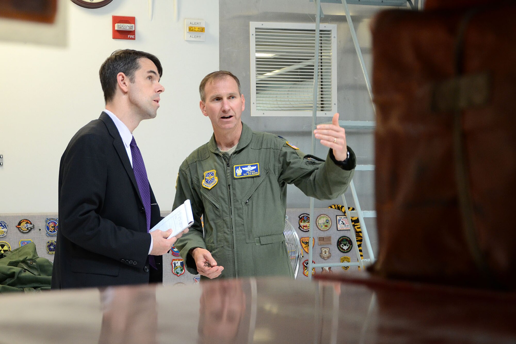 PEASE AIR NATIONAL GUARD BASE, N.H. – Lieutenant Col. James Ryan, 133rd Air Refueling Squadron commander, explains to Brad Bowman, the senior military legislative assistant for U.S. Senator Kelly Ayotte, the many features of the new 157th Operatons Group building during a visit to the base June 27. During the visit, N.H. Army National Guard Lt. Col. Roy Hunter, president of the National Guard Association of N.H., presented Bowman the General John Stark Award. Bowman was instrumental in the 157 ARW obtaining funding for the Deployment Cycle Support – Care Coordination Program and the wing’s quest to receive the KC-46A refueling tanker while in his role as senior military legislative lead to the senator. (N.H. Air National Guard photo by Tech. Sgt. Mark Wyatt)