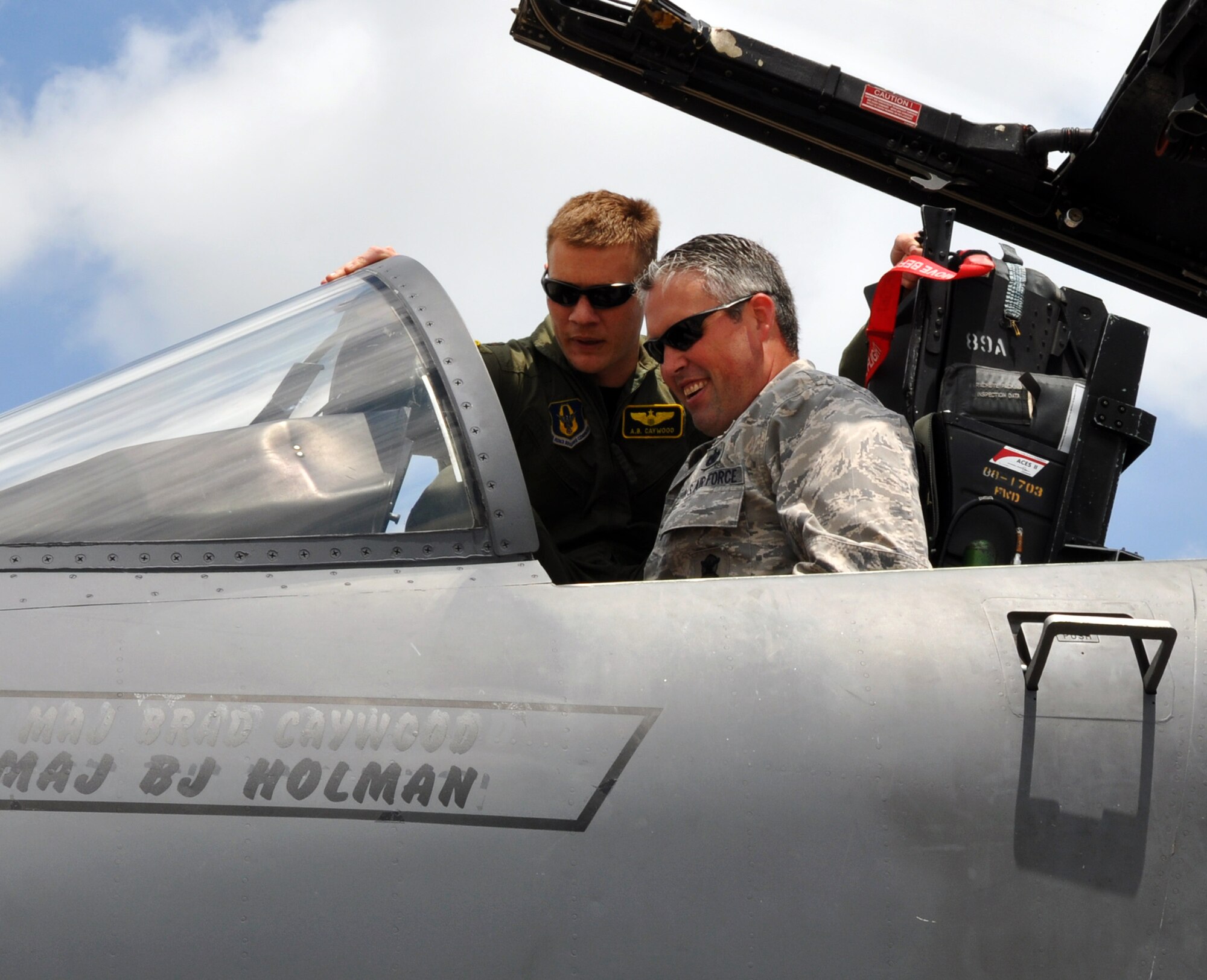 A reunion of Reservists! Maj. Brad Caywood, an F-15E Strike Eagle pilot assigned to Seymour-Johnson Air Force Base, N.C., shows the cockpit of his aircraft to Maj. Toby Kennedy, commander of the 931st Security Forces Squadron, on the flightline at McConnell Air Force Base, Kan., June 27, 2014. The two Air Force Reservists had been classmates while attending Squadron Officer School at Maxwell Air Force Base, Ala., in 2007 and were reunited when Caywood made a stop at McConnell during a cross-country flight. (U.S. Air Force photo by Capt. Zach Anderson)