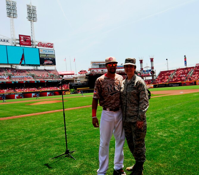 Col. Cassie Barlow, 88 Air Base Wing commander, poses with Reds center fielder Billy Hamilton. Hamilton was her catcher when she threw out the ceremonial first pitch of the game (Photo by Cindy Holbrook) . 