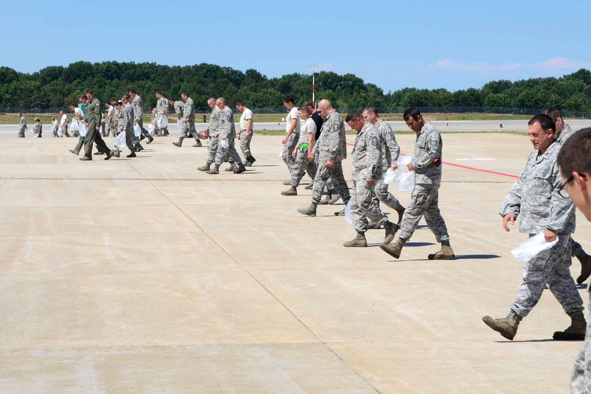 PEASE AIR NATIONAL GUARD BASE, N.H. – More than 50 Airmen participate in a foreign object debris walk, or FOD walk, on the flightline here June 27. The 157th Air Refueling Wing Airmen collected more than 40 pounds of debris. Among the items collected were bolts, safety wire, vehicle parts and more. (N.H. Air National Guard photo by Tech. Sgt. Mark Wyatt)