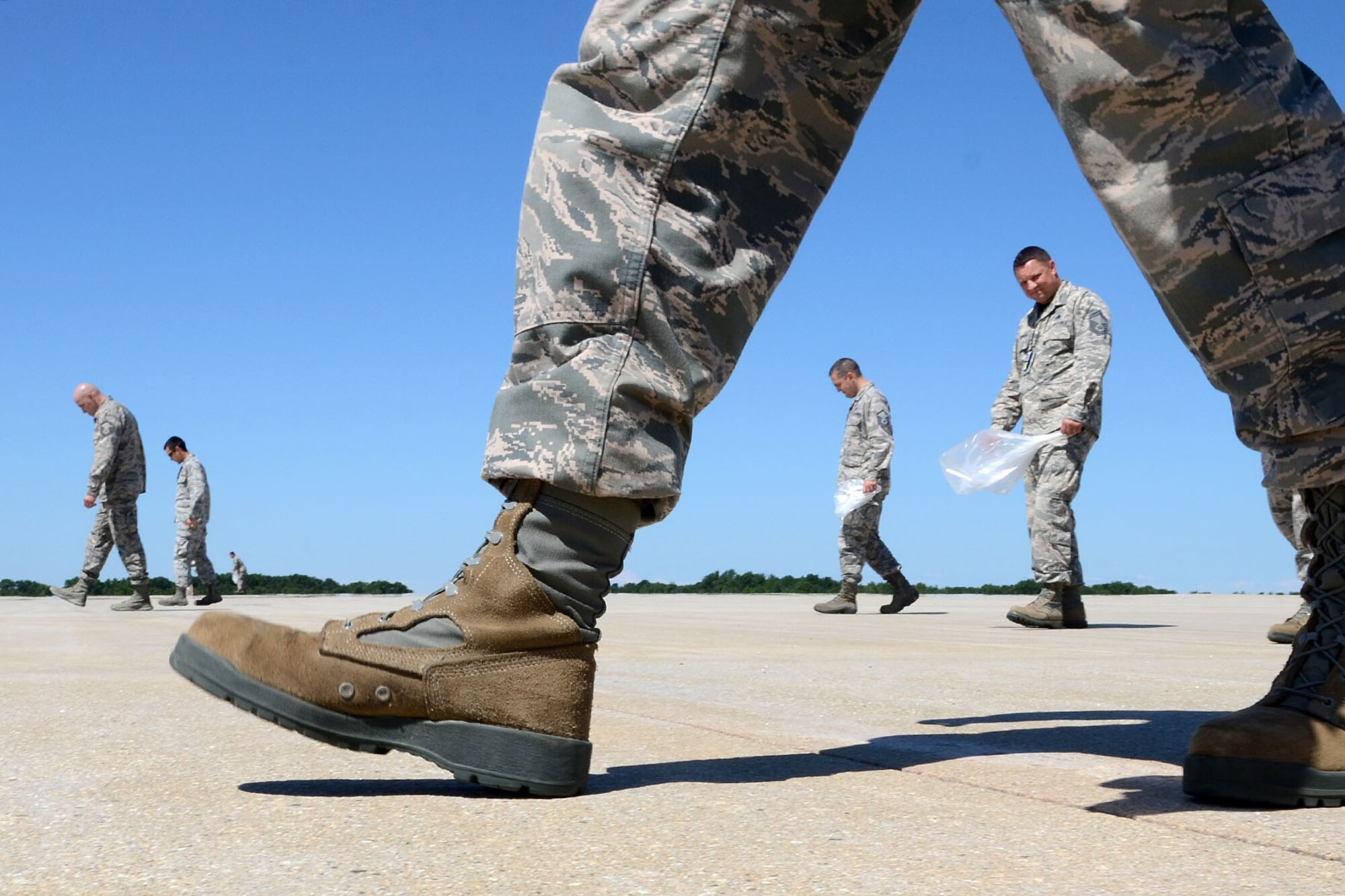 PEASE AIR NATIONAL GUARD BASE, N.H. – More than 50 Airmen participate in a foreign object debris walk, or FOD walk, on the flightline here June 27. The 157th Air Refueling Wing Airmen collected more than 40 pounds of debris. Among the items collected were bolts, safety wire, vehicle parts and more. (N.H. Air National Guard photo by Tech. Sgt. Mark Wyatt)