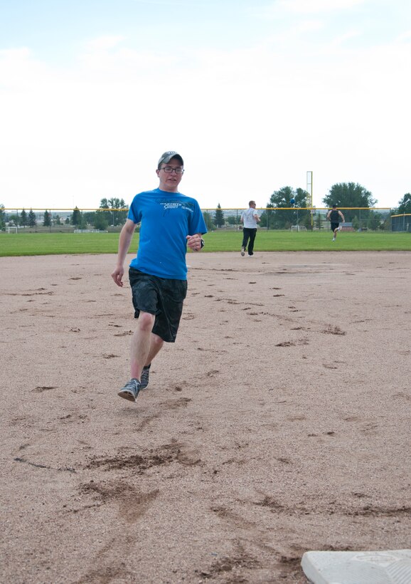 Airman 1st Class James Allison, 90th Civil Engineer Squadron structures, sprints to third during a kickball game the 90th CES played June 25, 2015, on one of the softball fields near the Freedom Hall Fitness Center. The base populace can use the fields for recreation, but should call the fitness center at 773-6175 to ensure the fields are not reserved. (U.S. Air Force photo by Airman 1st Class Jason Wiese)