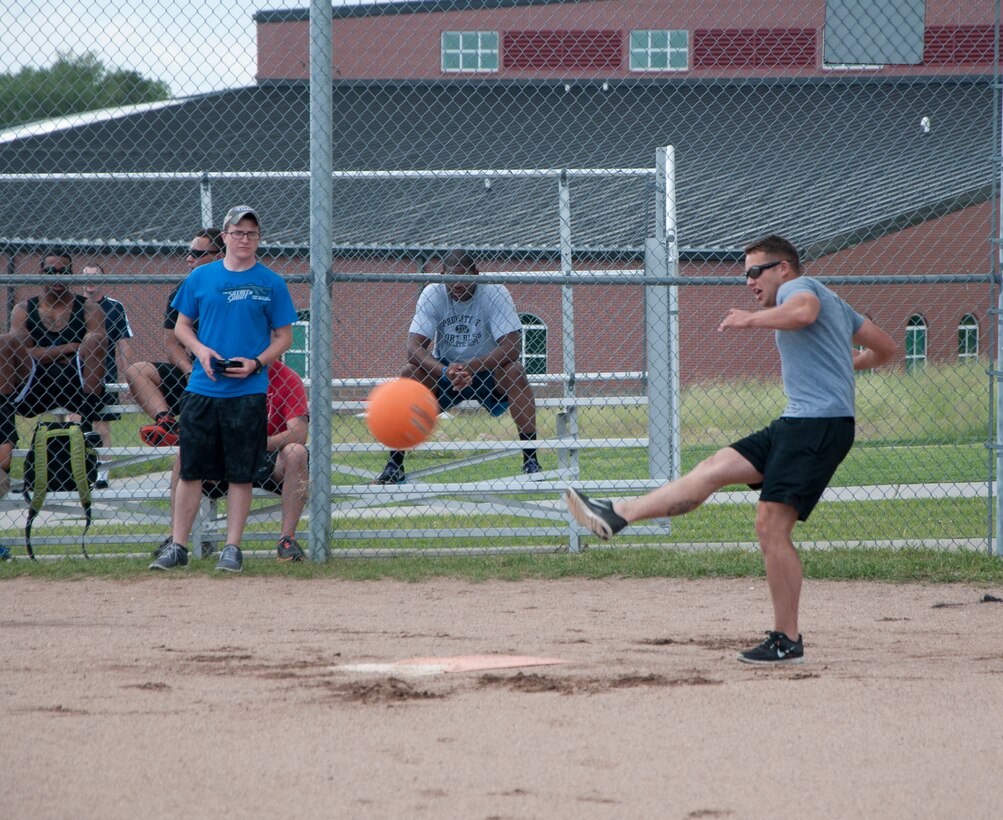 Senior Airman Donald Neal II, 90th Civil Engineer Squadron structures, kicks a kickball during a 90th CES sports day on one of the softball fields near the Freedom Hall Fitness Center June 25, 2014. (U.S. Air Force photo by Airman 1st Class Jason Wiese)