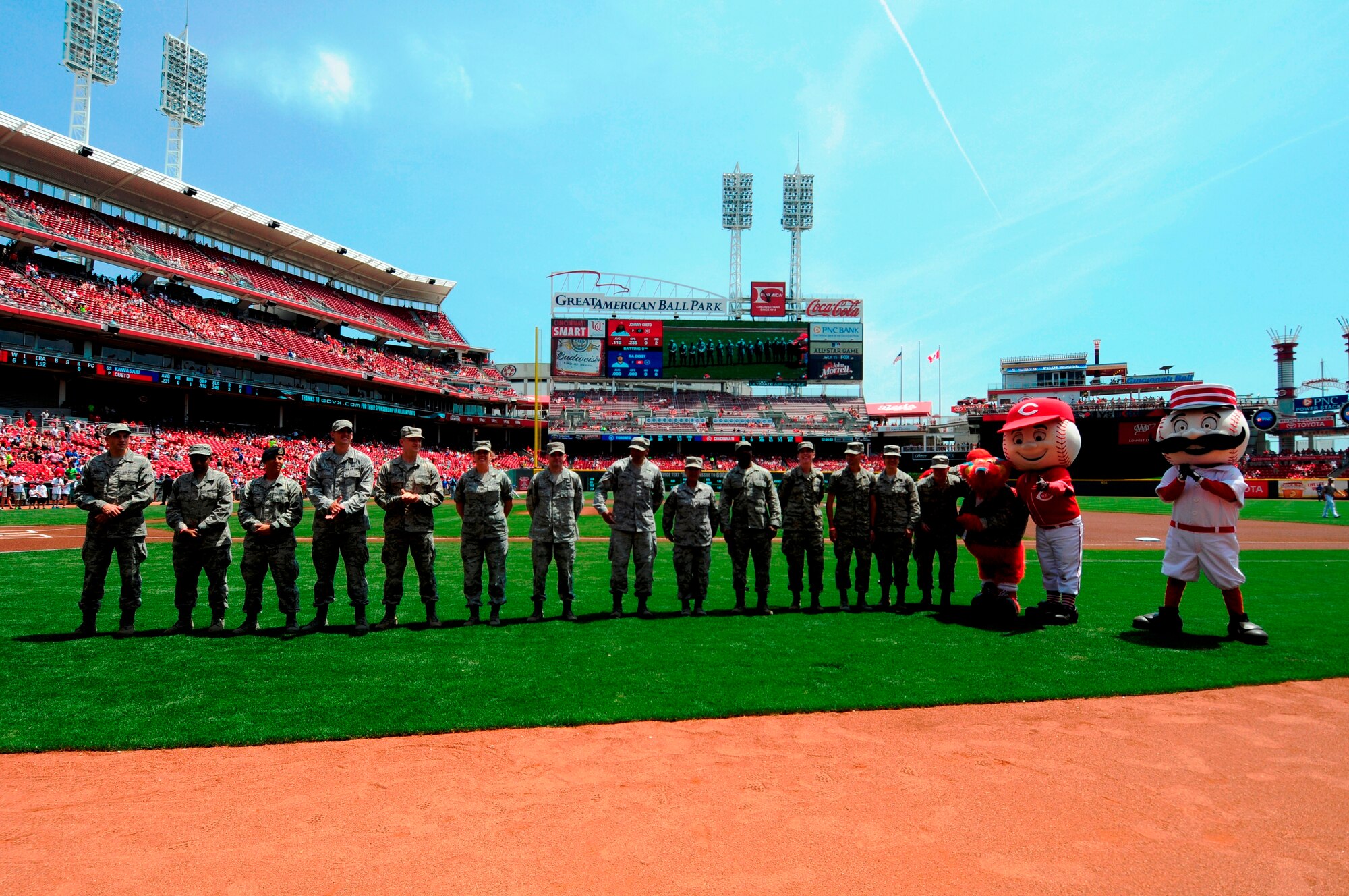Cincinnati Reds mascots Gapper, Mr. Red and Mr. Redlegs joined recently deployed Airmen that were welcomed home on the field June 22 for the Military Appreciation Day at Great American Ball Park during pre-game festivities. Among those recently returned were Airman 1st Class James Mrosko, Senior Airman Dylan Maughan, Senior Airman Jeremy Quint, Senior Airman Matthew Schwin, Staff Sgt. Robert Gregory, Master Sgt. Kelley Breen, Airman 1st Class Anastasia Hetter, Staff Sgt. Charles Prowell, Airman 1st Class Brionna Coleman, Tech. Sgt. Jean Aspiras, Senior Airman Kayla Ford, Tech. Sgt. Tyson Campbell, Capt. David Bereda and Sr. Airman Joseph Casciari (Photo by Cindy Holbrook).