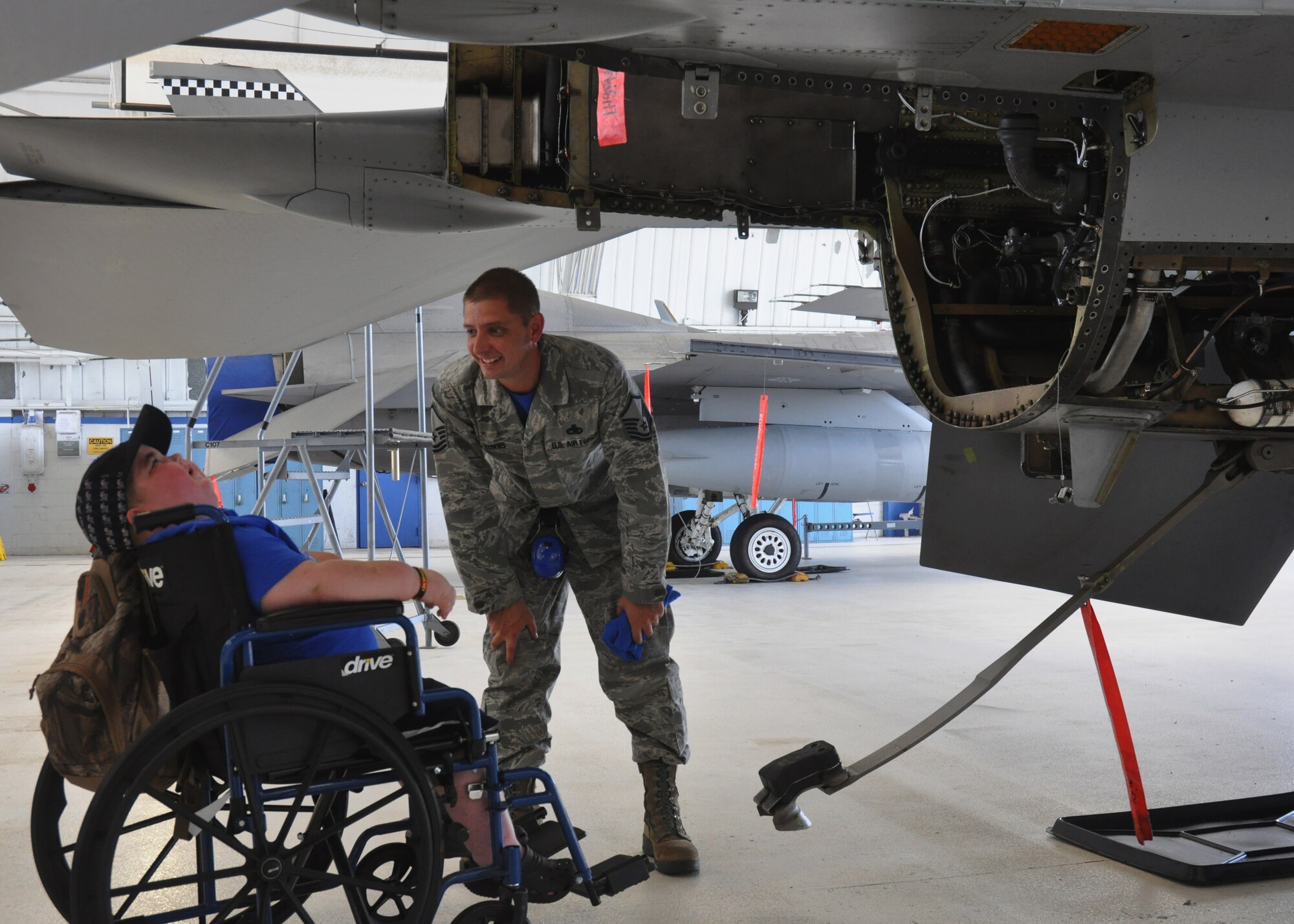 Special guest Derek Vincent, 6, asks Master Sgt. Zechary Towns, of the 96th Aircraft Maintenance Squadron, questions about an F-16 Fighting Falcon at Eglin Air Force Base, Fla. June 27. Vincent was diagnosed with a brain tumor in January and recently battled six weeks of radiation unsuccessfully so the squadron provided a tour for the family from Memphis, Tenn. To show support to their Airman who is a long-time family friend of the boy from his hometown, the 96th AMXS let Vincent spend two hours on the job with them. (U.S. Air Force photo/Chrissy Cuttita)