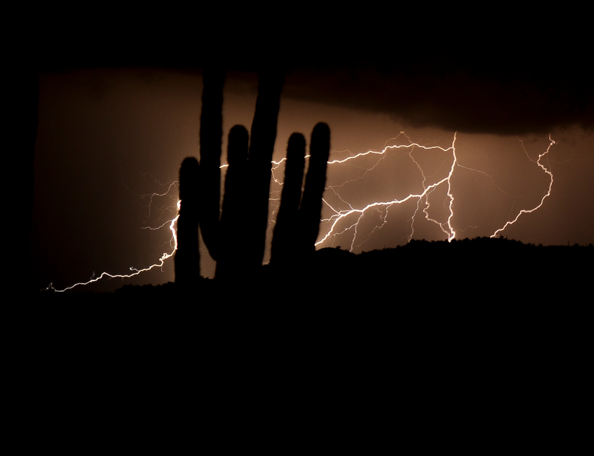 Lightning strikes over the White Tank Mountain Range Aug. 26, 2013, during a thunderstorm as seen from the end of the runway. Residents of Luke Air Force Base and the surrounding area were treated to nature’s light show, high winds and heavy rain. (U.S. Air Force photo/Staff Sgt. C.J. Hatch)