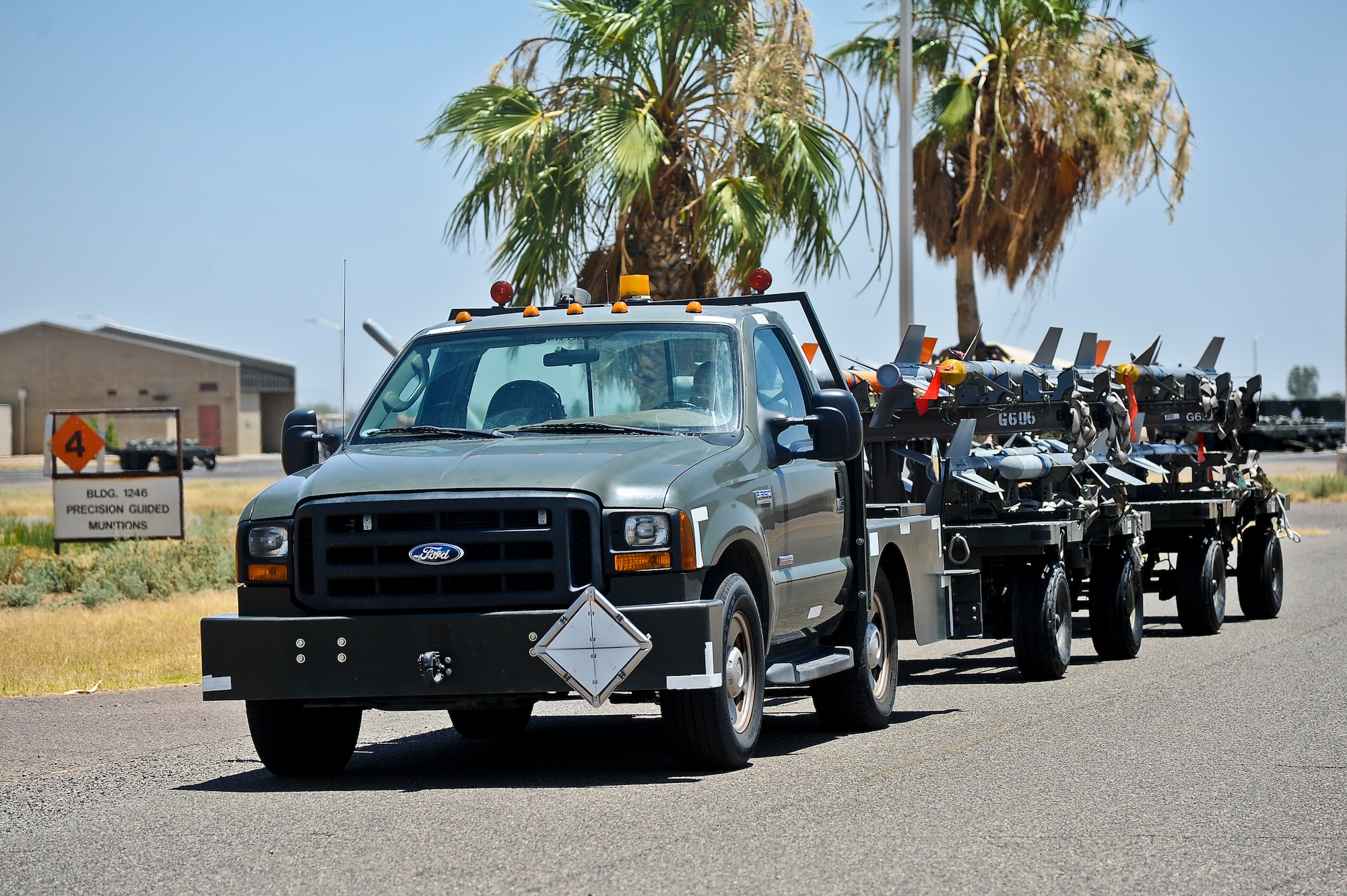 Senior Airman Valerie Pessefal, 56th Equipment Maintenance Squadron munitions line crew member, tows a missile trailer at Luke Air Force Base. The missiles are being towed from the precision guided munitions section to the flightline. (U.S. Air Force photo/Airman 1st Class Pedro Mota)