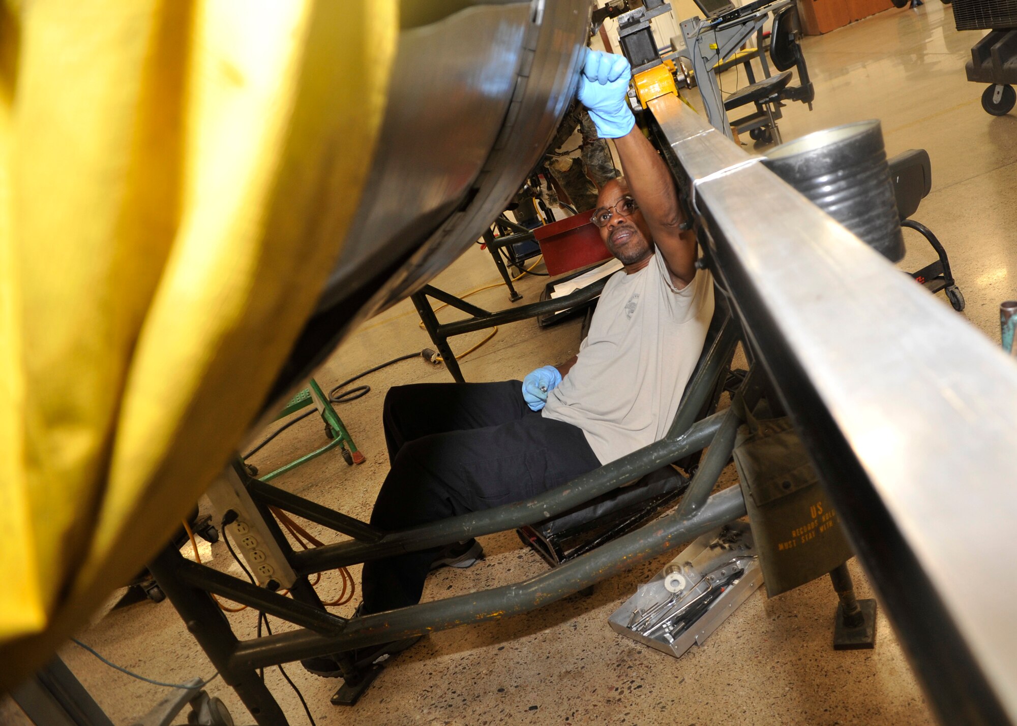 Andre Gandy, 56th CMS jet engine mechanic, installs an augmenter L-flange bracket on an F-16 Fighting Falcon engine.  CMS is responsible for scheduled maintenance of aircraft propulsion, avionics, low altitude navigation and targeting infrared for night pods, pneudraulics, electrical-environmental, egress and fuel systems used by more than 190 organizations on Luke and throughout the Southwest. (U.S. Air Force photo/Senior Airman Marcy Copeland)