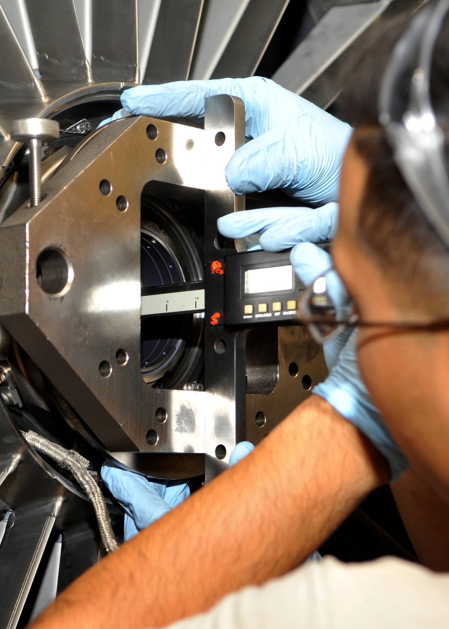 Airman 1st Class Joseph Nunez, 56th CMS, takes an electronic measurement of an engine core. Each F100-220 engine costs an estimated $3.2 million in repairs done at Luke, saving the Air Force money every year by not having to ship them out. The Jet Engine Intermediate Maintenance flight works 24 hours a day with 28 people per shift with crews of four to five people to produce one engine every 240 hours. (U.S. Air Force photo/Senior Airman Marcy Copeland)