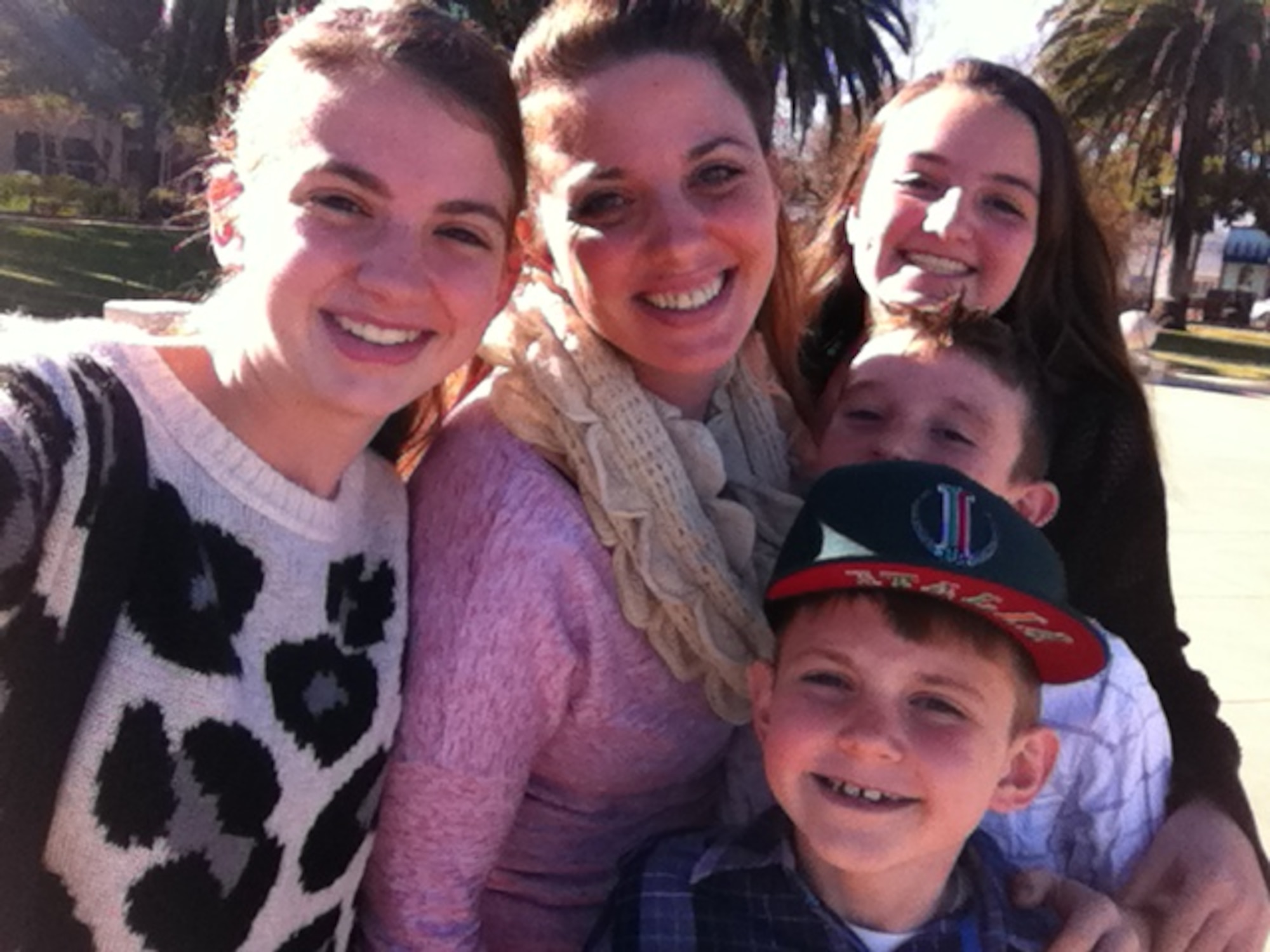Master Sgt. Shalien Edmondson, 21st Airlift Squadron first sergeant, a single mother of four, takes a family photo with her children. (Courtesy photo)