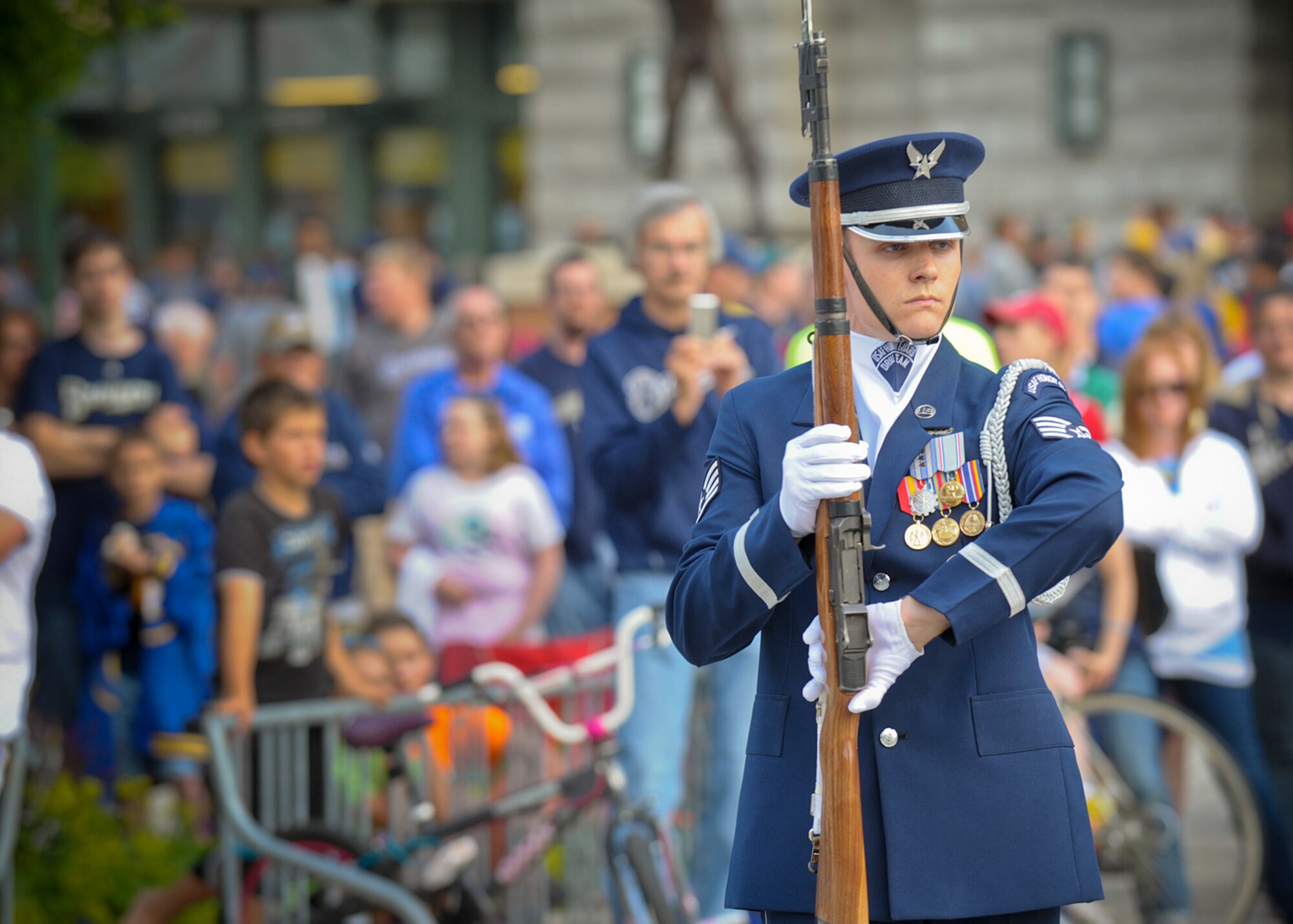 Staff Sgt. Daniel Sellstrom completes a "backdrop" maneuver during a performance at Miller Park in Milwaukee, June 23, 2014. Sellstrom, a Tucson, Ariz., native, joined the Air Force in 2008 and has been with the drill team since November 2013. The drill team is on a nine-day, seven-city tour with the Air Force band rock ensemble Max Impact across Wisconsin, Minnesota, South Dakota, Wyoming and Nebraska. (U.S. Air Force Photo/ 1st Lt. Nathan Wallin)