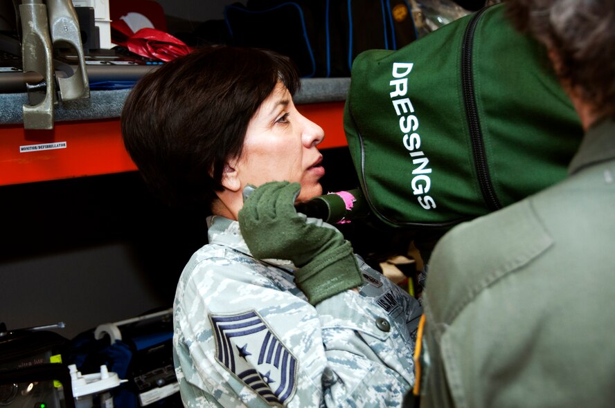 Chief Master Sgt. Ericka Kelly, 349th Air Mobility Wing command chief, lends a hand to help arrange equipment in storage June 9 on Travis. (U.S. Air Force photo/Staff Sgt. Patrick Harrower)