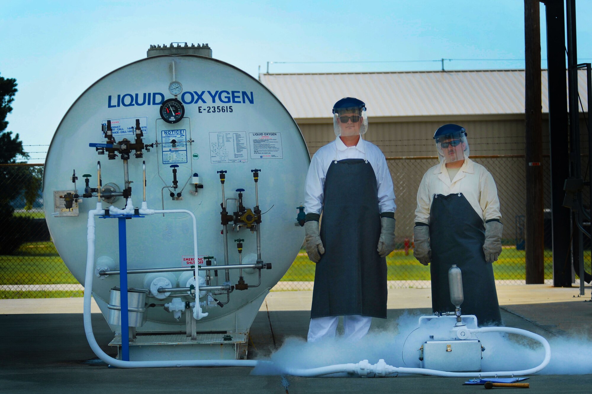 [From left] U.S. Air Force Tech. Sgt. Jason Powers, 20th Logistics Readiness Squadron NCO in charge of fuels fixed facilities, and Staff Sgt. Adam Rozell, 20th LRS fuels fixed facilities supervisor, stand in their protective gear beside a liquid oxygen tank during routine sampling at Shaw Air Force Base, S.C., June 26, 2014. The two cryogenic experts take samples from the liquid oxygen tank approximately every 60 days. Once collected, samples are sent to Wright-Patterson AFB, Ohio for purity testing. (U.S. Air Force photo by Airman 1st Class Jensen Stidham/Released) 