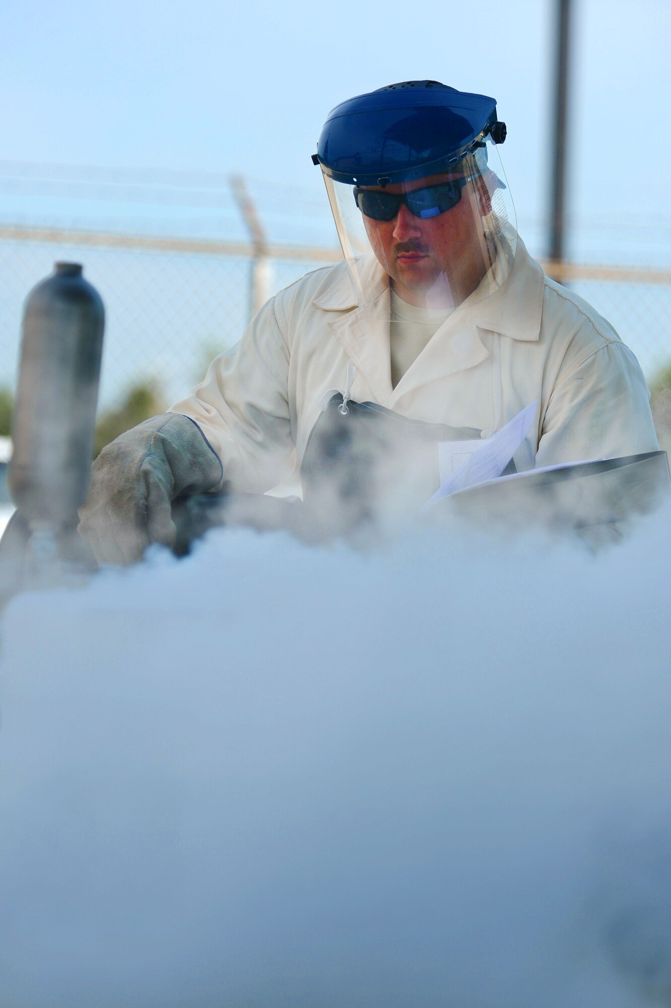U.S. Air Force Staff Sgt. Adam Rozell, 20th Logistics Readiness Squadron fuels fixed facilities supervisor, fills a liquid oxygen tank at Shaw Air Force Base, S.C., June 26, 2014. Rozell, one of two specially trained cryogenic experts here, filled the tank using a liquid oxygen sampling kit in preparation for purity testing. (U.S. Air Force photo by Airman 1st Class Jensen Stidham/Released)