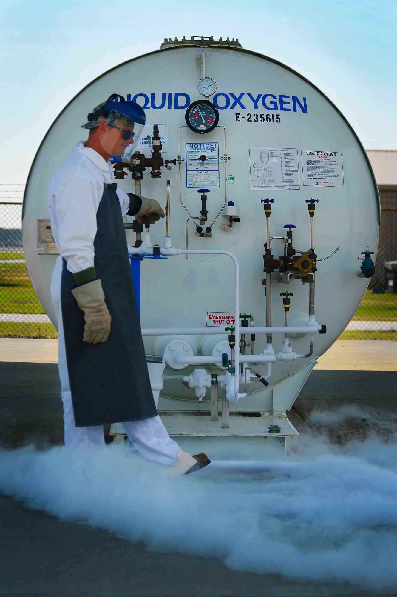 U.S. Air Force Tech. Sgt. Jason Powers, 20th Logistics Readiness Squadron NCO in charge of fuels fixed facilities, releases a valve on a liquid oxygen tank at Shaw Air Force Base, S.C., June 26, 2014. Powers, one of two specially trained cryogenic experts here, released the liquid oxygen into a smaller tank, which is then inverted, forming a gas, and it is then tested for purity. (U.S. Air Force photo by Airman 1st Class Jensen Stidham/Released)