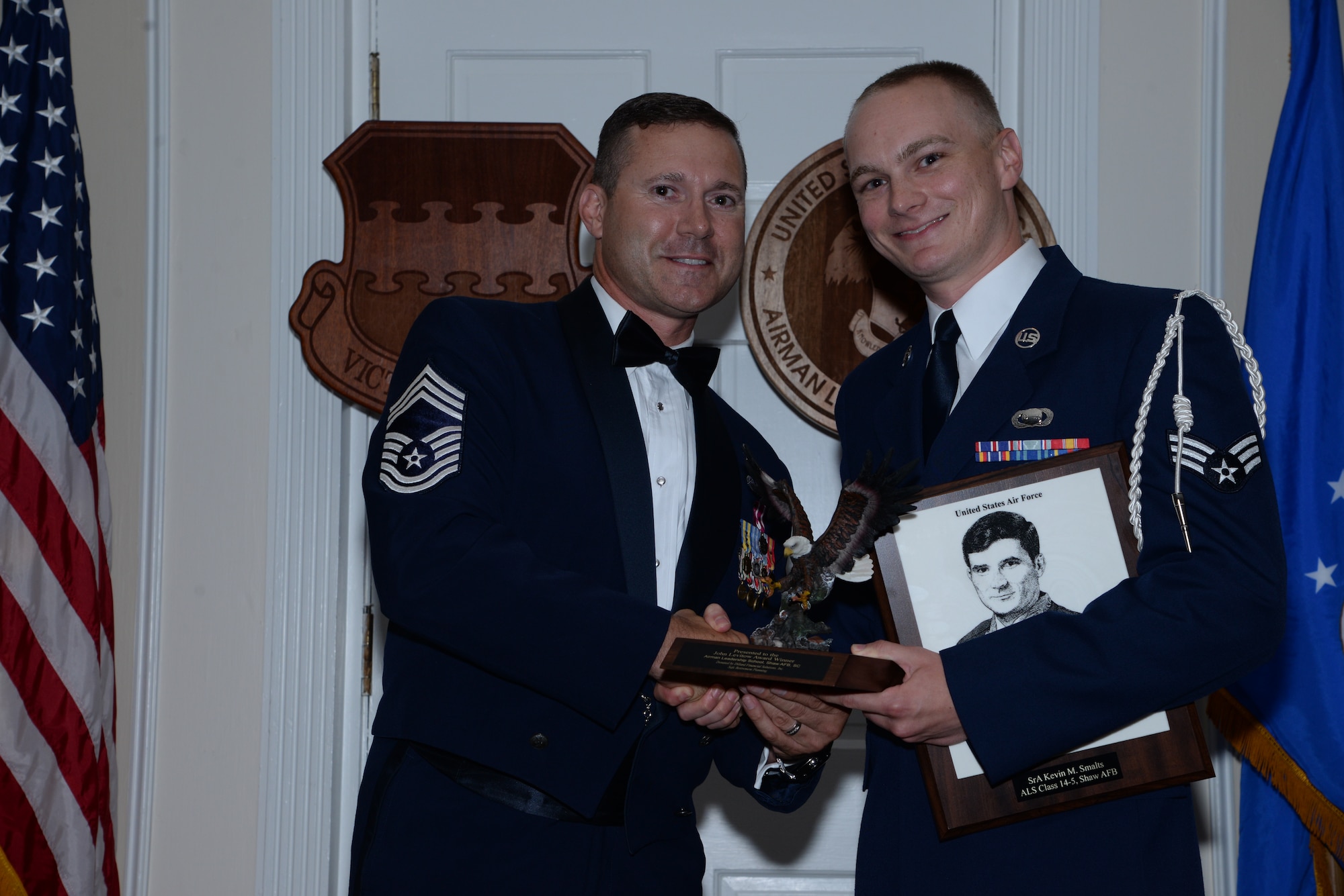 U.S. Air Force Senior Airman Kevin Smalts, 31st Intelligence Squadron, receives the Senior Master Sgt. David B. Reid Airman Leadership School Class 14-5 John L. Levitow Award from Chief Master Sgt. Michael Restivo, 20th Medical Group superintendent, during the class’ graduation ceremony at Shaw Air Force Base, S.C., June 26, 2014. The Levitow Award is given to the graduate with the highest average of instructor and student points, and is the highest award in enlisted professional military education. (U.S. Air Force photo by Airman 1st Class Jonathan Bass/Released)