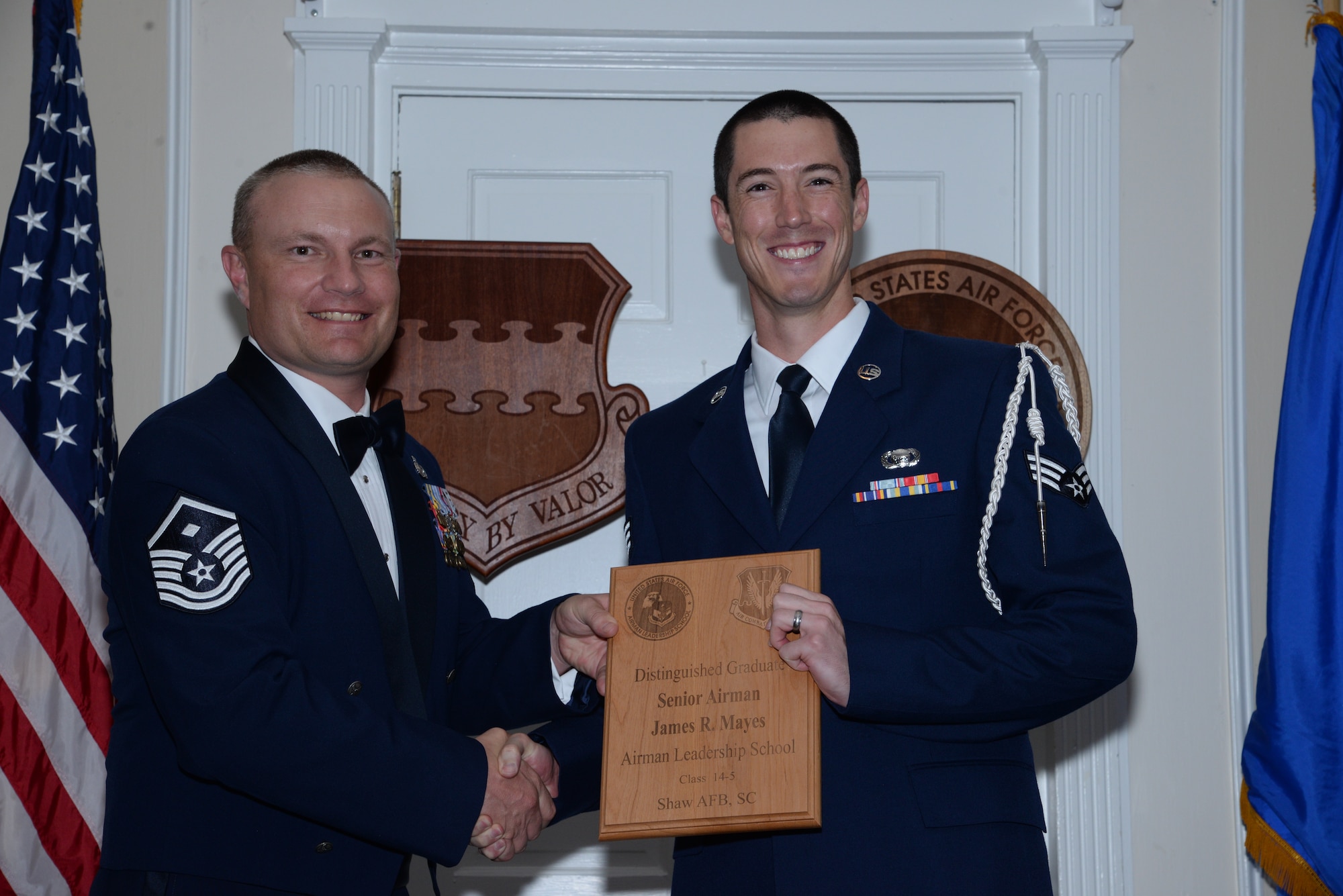 U.S. Air Force Senior Airman Adam Klein, 31st Intelligence Squadron (right), receives one of the Senior Master Sgt. David B. Reid Airman Leadership School Class 14-5 distinguished graduate awards from Master Sgt. Gregory Spiczka, 20th Security Forces Squadron first sergeant during the class’ graduation at Shaw Air Force Base, S.C., June 26, 2014. These awards are given to the top 10 percent of Airmen in the class for total point accumulation. (U.S. Air Force photo by Airman 1st Class Jonathan Bass/Released)