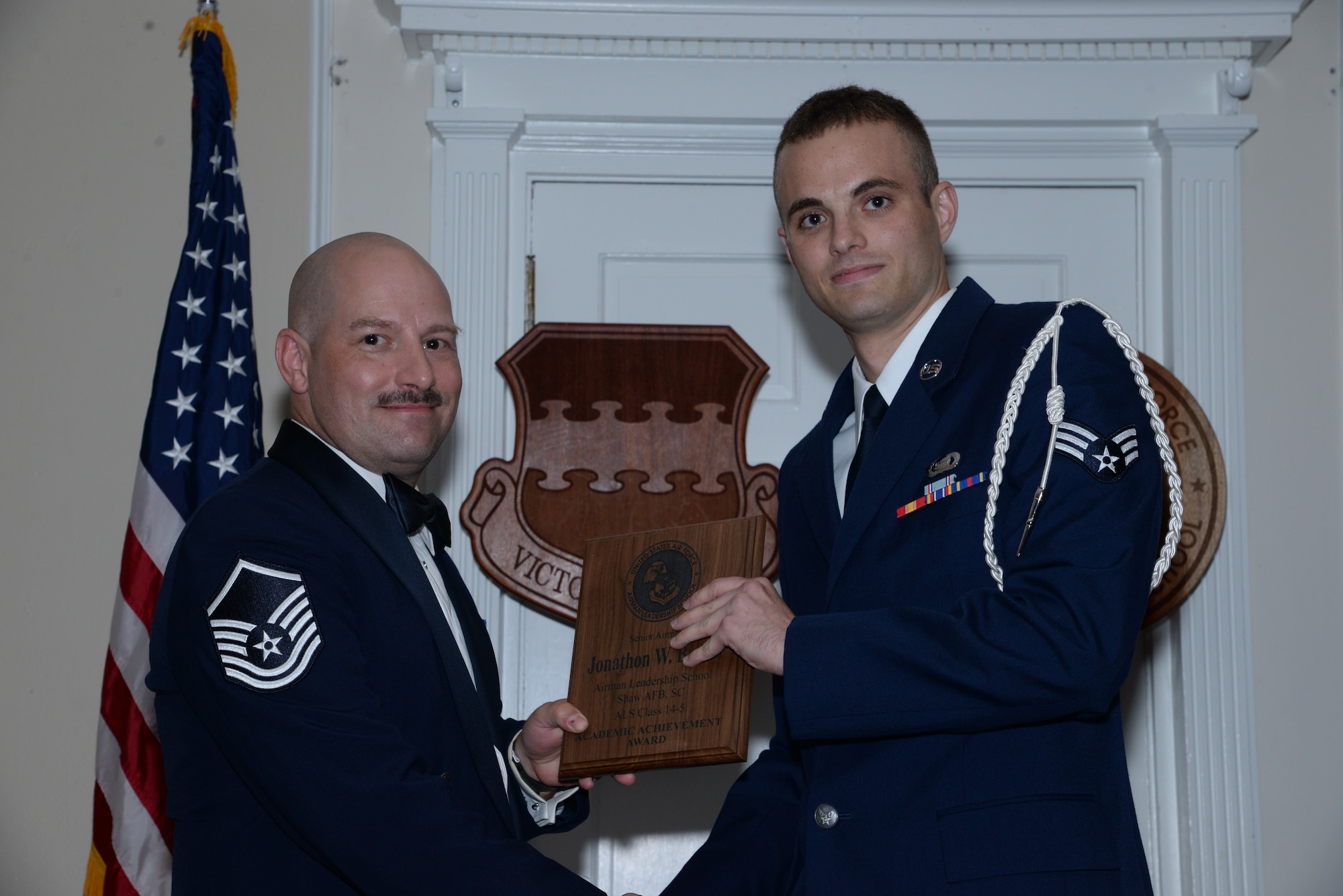 U.S. Air Force Senior Airman Jonathon Brown, 3rd Intelligence Squadron (right), receives the Senior Master Sgt. David B. Reid Airman Leadership School Class 14-5 Academic Award from Master Sgt. Adam Weinberg, 20th Logistics Readiness Squadron knowledge operations manager, during the class’ graduation ceremony at Shaw Air Force Base, S.C., June 26, 2014. This award is given to the Airman who has the highest point total. (U.S. Air Force photo by Airman 1st Class Jonathan Bass/Released)