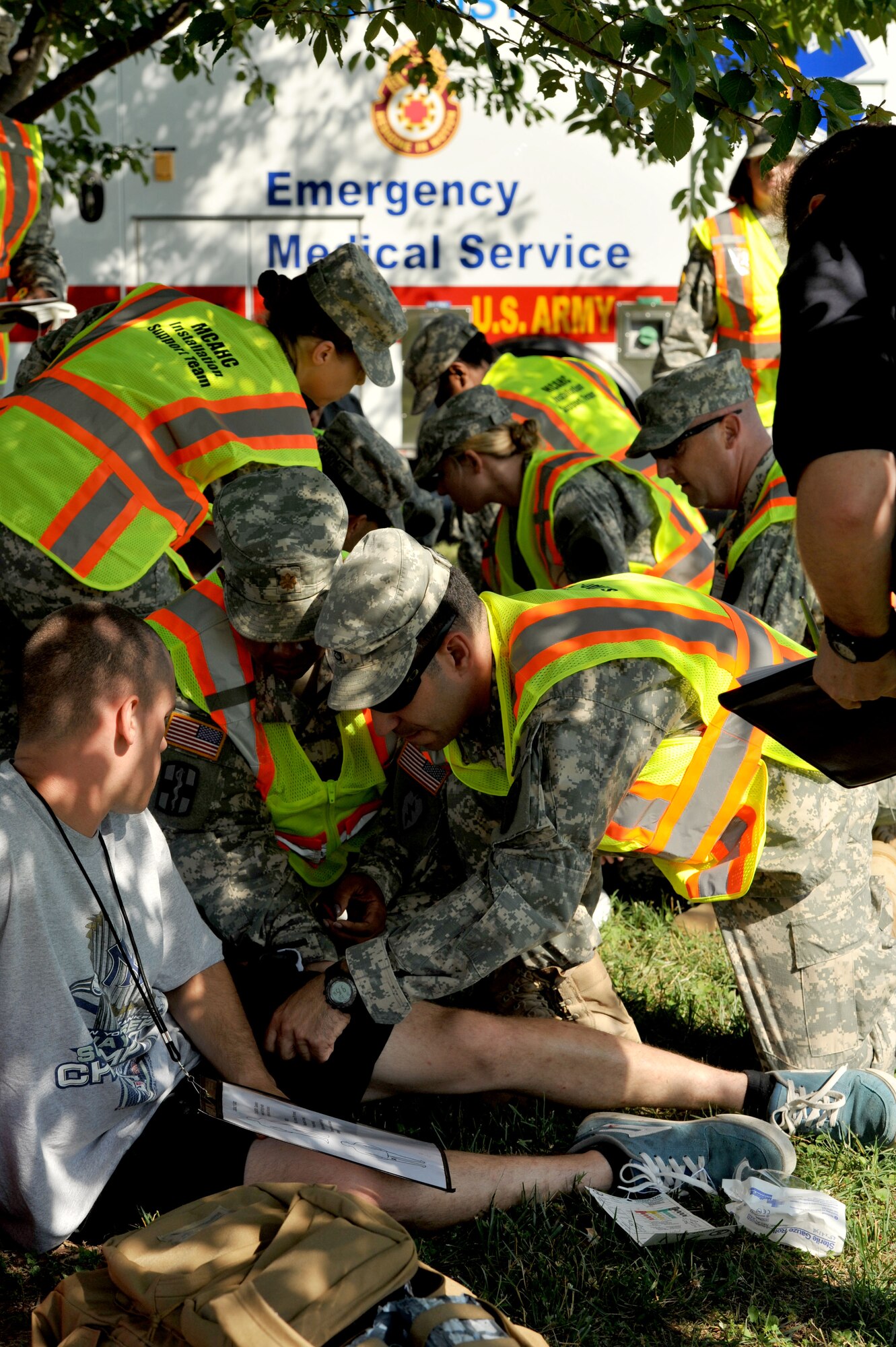 Members of the McDonald Army Health Center Installation Support Team at Fort Eustis Emergency Medical Services treat simulated casualties during an active shooter exercise at Fort Eustis, Va., June 26, 2014.  The exercise involved multiple emergency support agencies, including the 733rd Security Forces Squadron, Fort Eustis Emergency Medical Services, the Fort Eustis Fire Department, McDonald Army Health Center and Newport News Fire Department. (U.S. Air Force photo by Staff Sgt. Katie Gar Ward/Released)