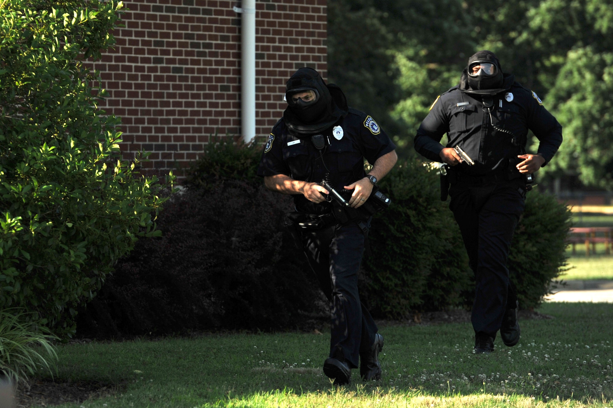 Members of the 733rd Security Forces Squadron respond during an active shooter exercise at Fort Eustis, Va., June 26, 2014. The exercise took place at General Stanford Elementary School, a Newport News public school located on post, and involved an active shooter injuring role-players who acted as teachers and students.  (U.S. Air Force photo by Staff Sgt. Katie Gar Ward/Released)