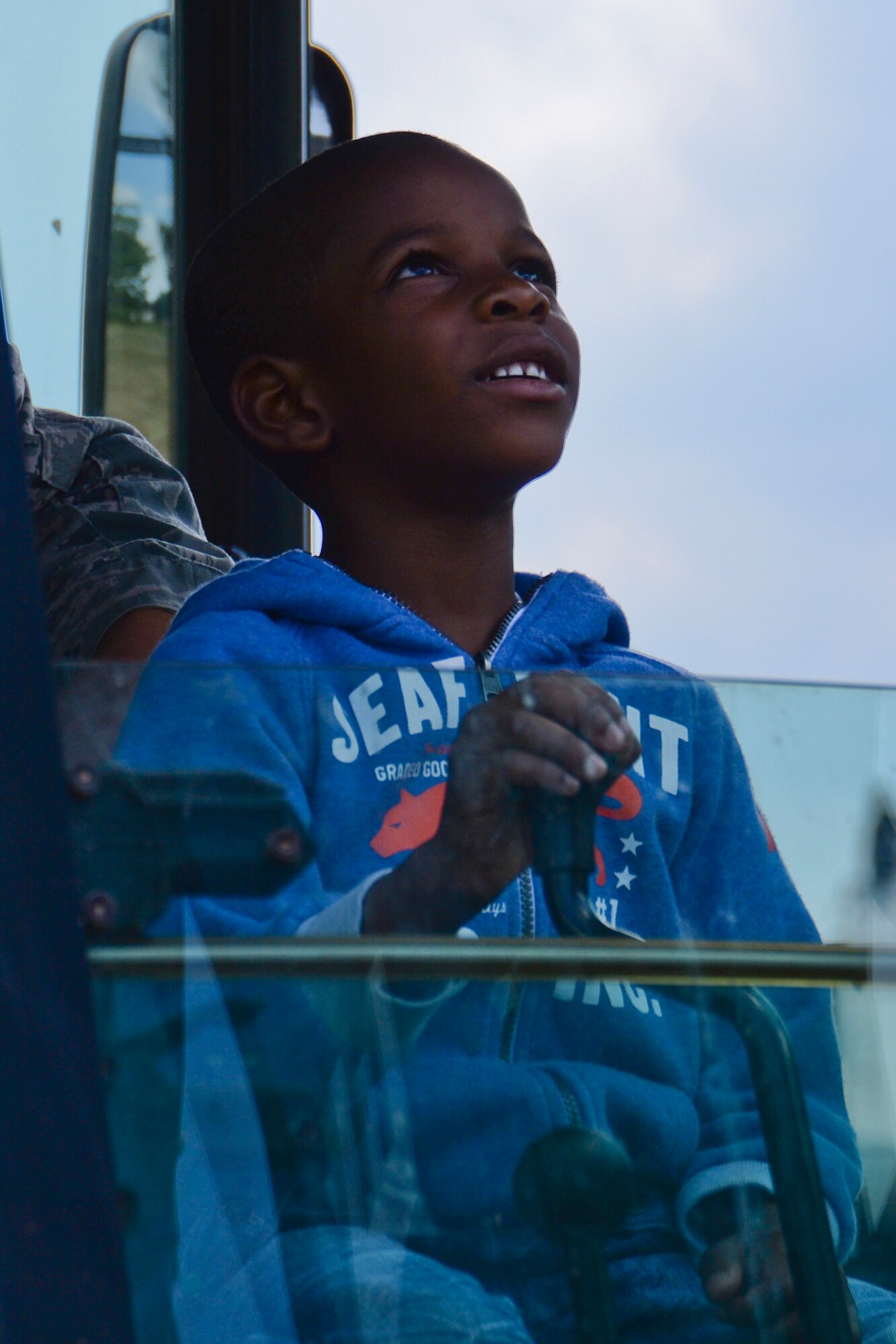Israel Kalu-Lucky, 6, son of U.S. Air Force Staff Sgt. Irisha Fayson, 52nd Force Support Squadron NCO in charge of re-enlistments, operates the crane on a backhoe during the 52nd Civil Engineer Squadron’s Career Day outside the 52nd FSS School Age Program building at Spangdahlem Air Base, Germany, June 18, 2014. The children learned about the work 52nd CES Airmen perform for the installation on a daily basis. (U.S. Air Force photo by Staff Sgt. Joe W. McFadden)