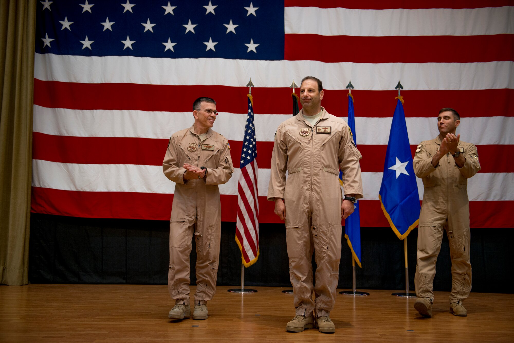 U.S. Air Force Col. Jason Hanover stands before the 386th Air Expeditionary Wing as they applaud after assuming command June 26, 2014 at an undisclosed location in Southwest Asia. Hanover assumed command after serving as the military assistant to the commander, NATO Special Operations Headquarters, Supreme Headquarters Allied Powers Europe in Belgium. (U.S. Air Force photo by Staff Sgt. Jeremy Bowcock)