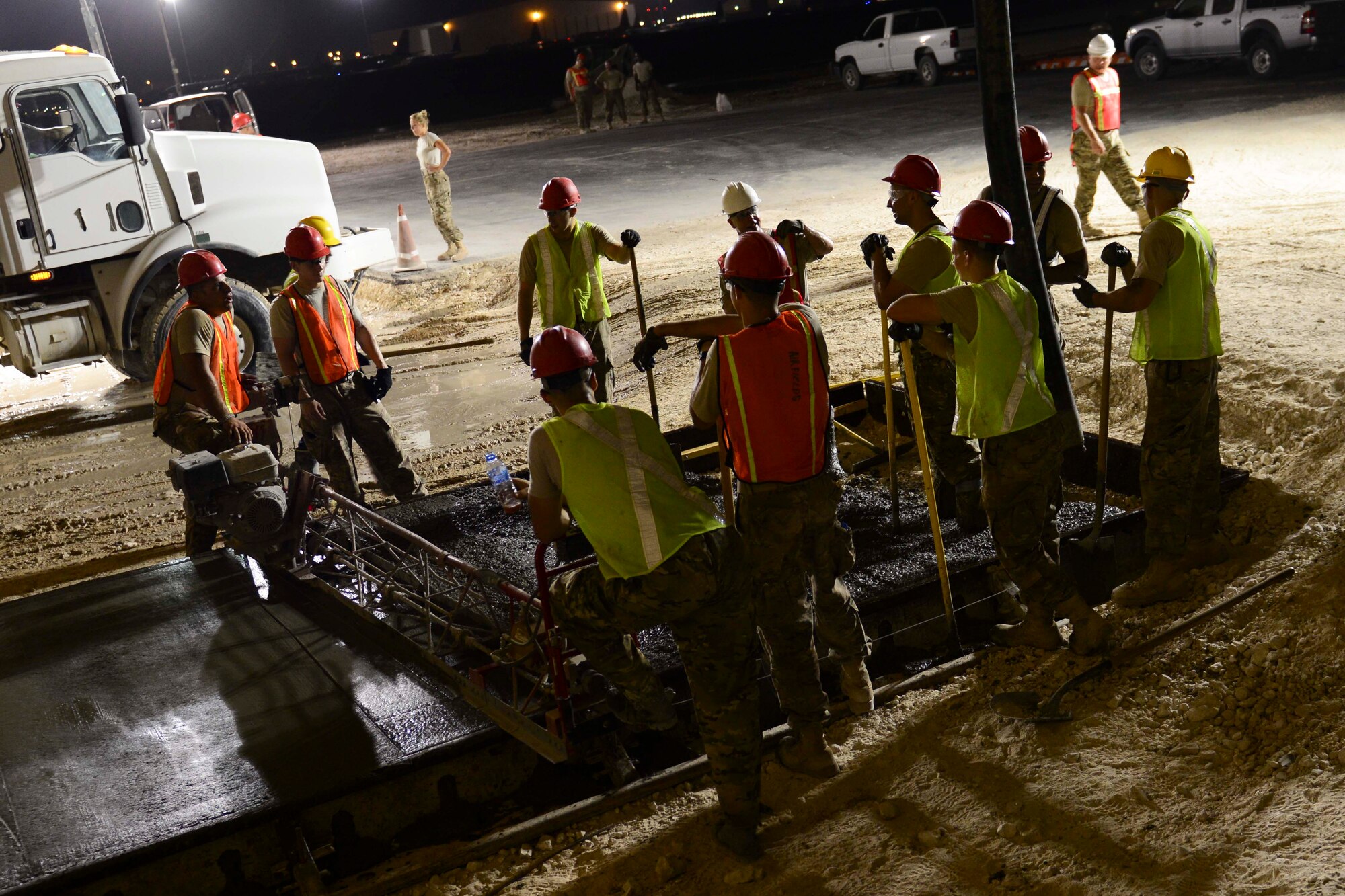 U.S. Air Force Airmen assigned to the 557th Expeditionary RED HORSE Squadron work to build a concrete pad at Al Udeid Air Base, Qatar, June 23, 2014. The concrete pad will be a part of an extension to a concrete pad already here for aircraft maintenance. (U.S. Air Force photo by Staff Sgt. Ciara Wymbs)  
