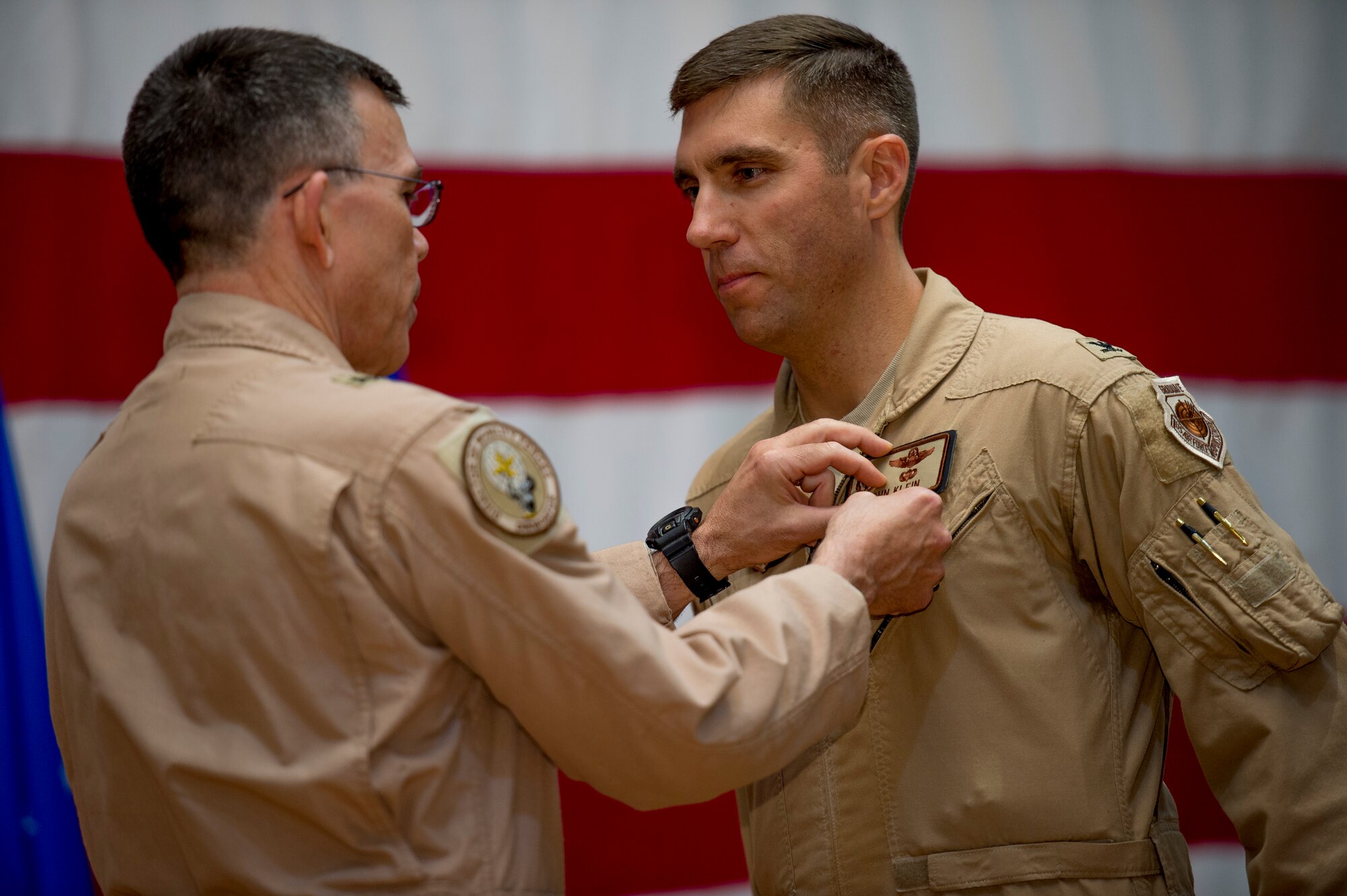 U.S. Air Force Brig. Gen. Timothy Frye, mobility forces director, presents Col. John Klein, 386th Air Expeditionary Wing commander, the Bronze Star June 26, 2014 at an undisclosed location in Southwest Asia. Klein was awarded the medal just before relinquishing command of the 386th AEW to Col. Jason Hanover during a formal change of command ceremony. (U.S. Air Force photo by Staff Sgt. Jeremy Bowcock)