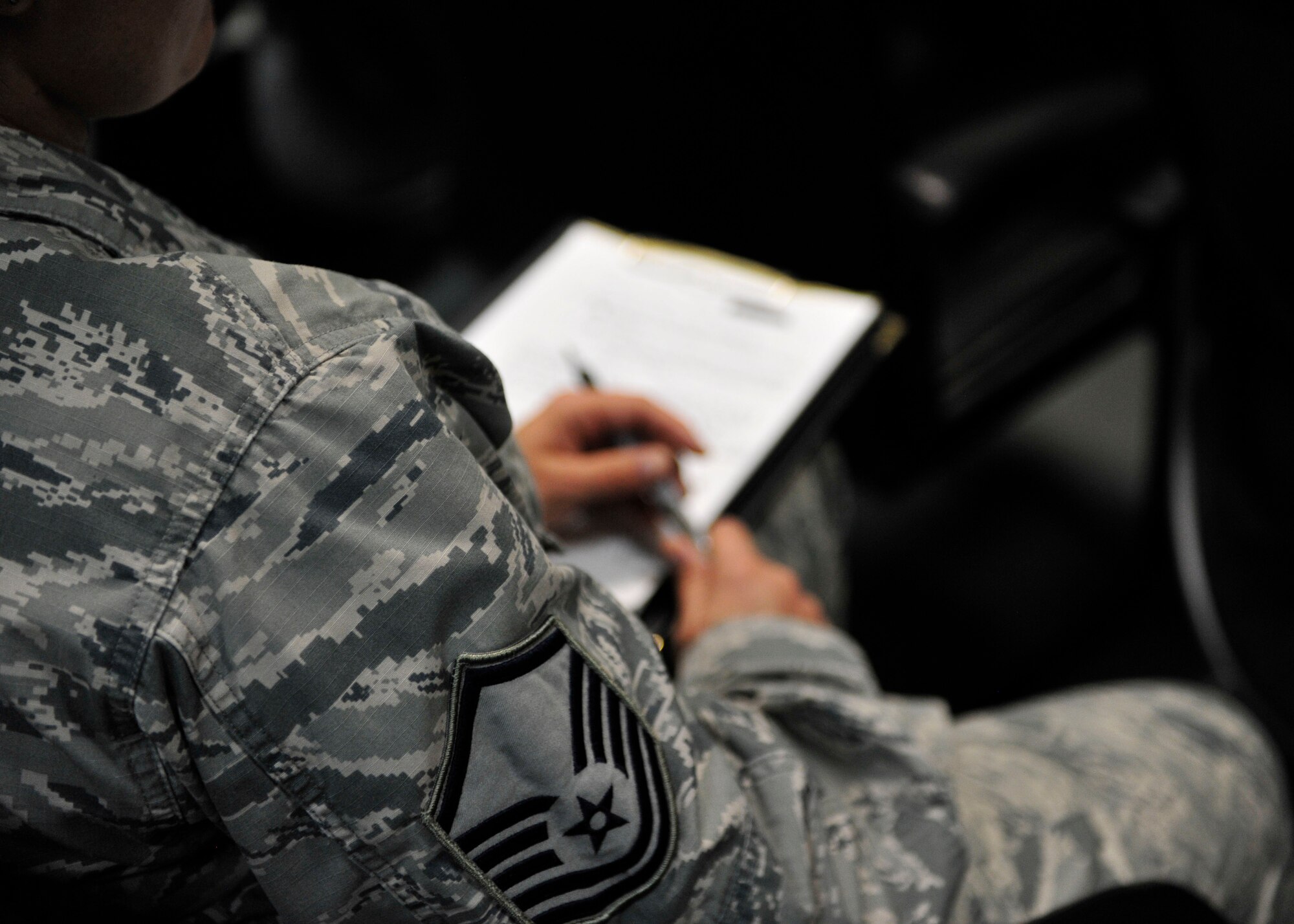 A U.S. Air Force Airman takes notes during a Desert Diamond Symposium at Al Udeid Air Base, Qatar, June 22, 2014. First sergeants must have a wide range of knowledge, such as personnel management , military training and Air Force organization.(U.S. Air Force photo by Senior Airman Colin Cates)