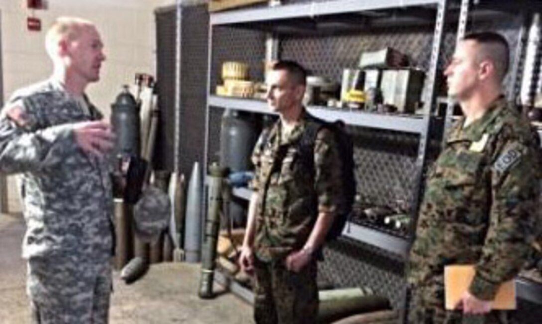 U.S. Army Capt. David Watkins, left, commander of the 55th Explosive Ordnance Disposal (EOD) Company, talks with Bosnian army soldiers Capt. Aleksandar Atelj, center, and Staff Sgt. Arnes Hodzic at Fort Belvoir in Virginia during the Bosnians’ visit to the United States. Courtesy photo
