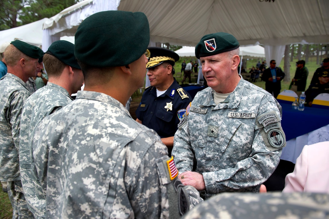 U.S. Army Brig. Gen. Sean P. Mulholland, right, commander of Special Operations Command South, shakes hands with U.S. soldiers during a graduation ceremony in Tegucigalpa, Honduras, June 19, 2014.