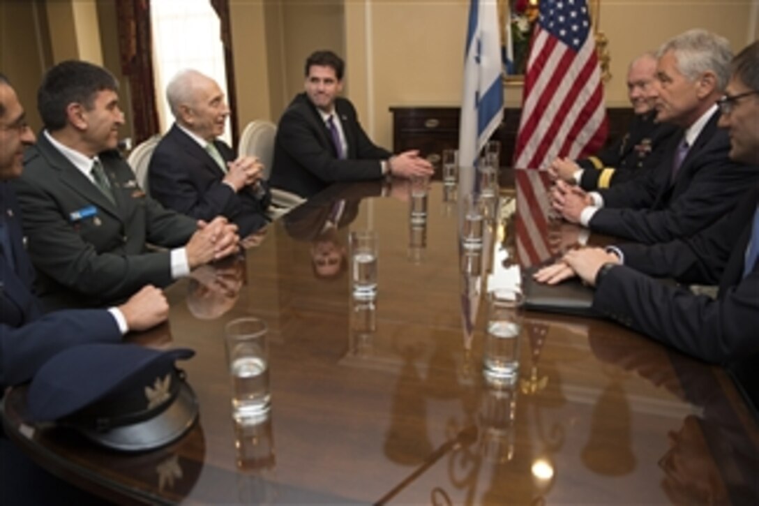U.S. Defense Secretary Chuck Hagel, center right, and U.S. Army Gen. Martin E. Dempsey, chairman of the Joint Chiefs of Staff, meet with Israeli President Shimon Peres at the Willard Intercontinental Hotel in Washington, D.C., June 26, 2014. The leaders discussed bilateral defense topics.
