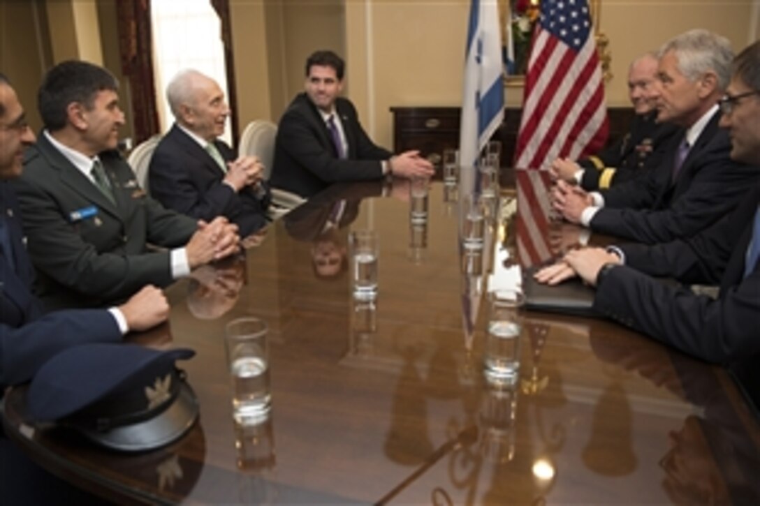 U.S. Defense Secretary Chuck Hagel, center right, and U.S. Army Gen. Martin E. Dempsey, chairman of the Joint Chiefs of Staff, meet with Israeli President Shimon Peres at the Willard Intercontinental Hotel in Washington, D.C., June 26, 2014. The leaders discussed bilateral defense topics.