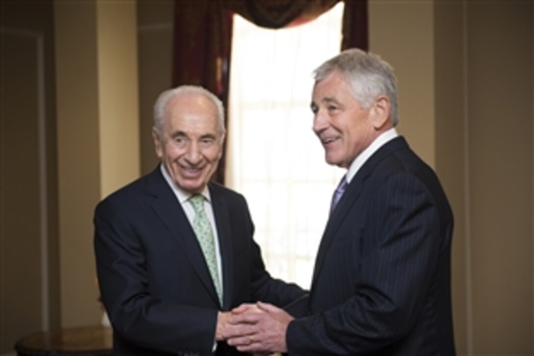U.S. Defense Secretary Chuck Hagel, right, greets Israeli President Shimon Peres during a meeting at the Willard Intercontinental Hotel in Washington, D.C., June 26, 2014. The leaders discussed bilateral defense topics.