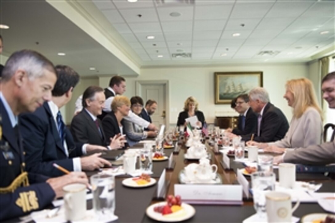 U.S. Defense Secretary Chuck Hagel, third from right, meets with Italian Defense Minister Roberta Pinotti, fourth from left, at the Pentagon, June 27, 2014, following an honor cordon welcome. Both leaders met to discuss matters of mutual concern.