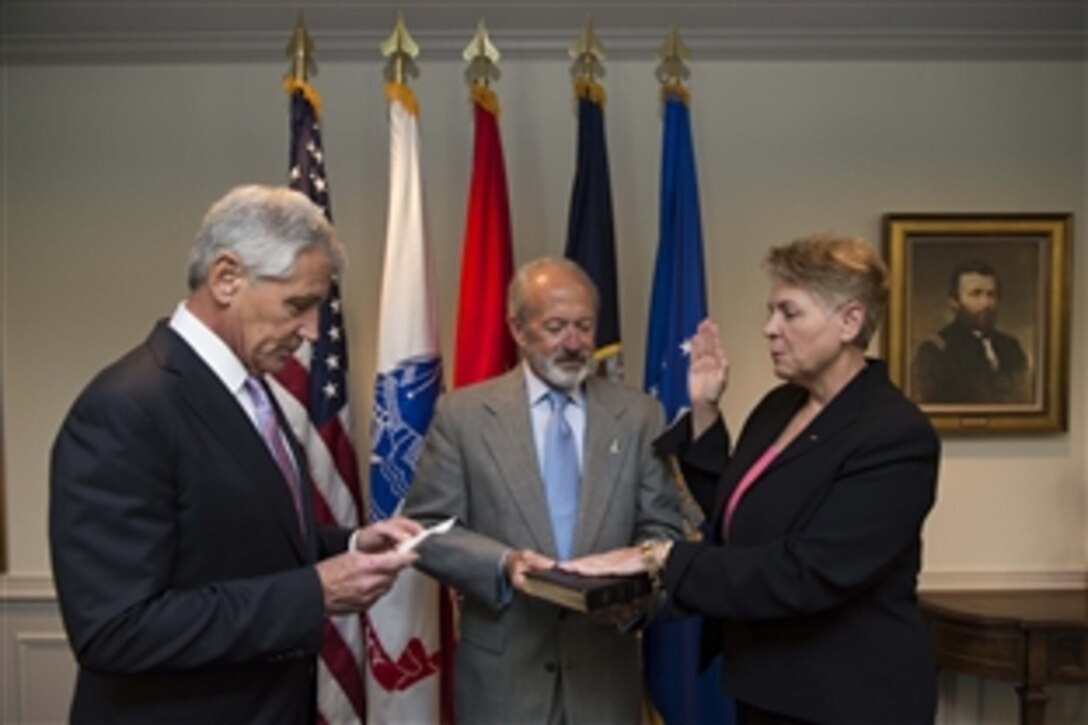 Defense Secretary Chuck Hagel swears in Jessica L. Wright as undersecretary of Defense for Personnel and Readiness during a ceremony at the Pentagon, June 27, 2014. Wright had served as acting undersecretary since January 1, 2013.