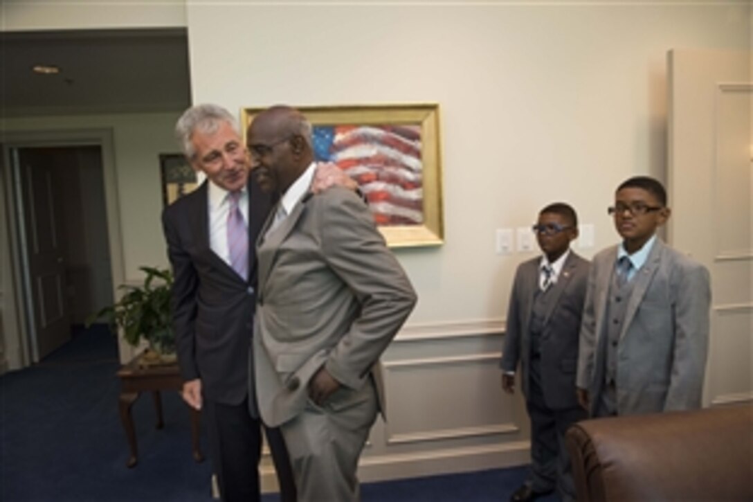 Defense Secretary Chuck Hagel meets with Lt. Jerome 'Skip' Johnson who served with Hagel during the Vietnam War, at the Pentagon June 27, 2014.  It was their first meeting since they served together in Vietnam.