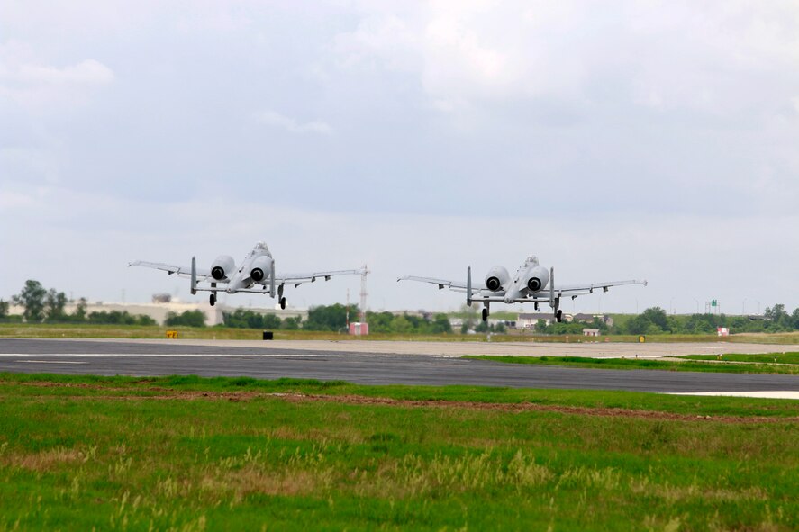 Two 188th Wing A-10C Thunderbolt II “Warthogs” piloted by Col. Mark Anderson, 188th Wing commander, and Maj. Doug Davis, 188th Detachment 1 commander, take off from Ebbing Air National Guard Base, Fort Smith, Arkansas, June 7, 2014. This sortie marked the wing’s final A-10 departure and capped the 188th’s Conversion Day ceremony, which recognized the many changes occurring at the wing as a result of its conversion to a remotely piloted aircraft (MQ-9 Reapers) and intelligence, surveillance and reconnaissance mission. The 188th Fighter Wing was also redesignated as the 188th Wing during the event. (U.S. Air National Guard photo by Staff Sgt. Matt Pelkey)