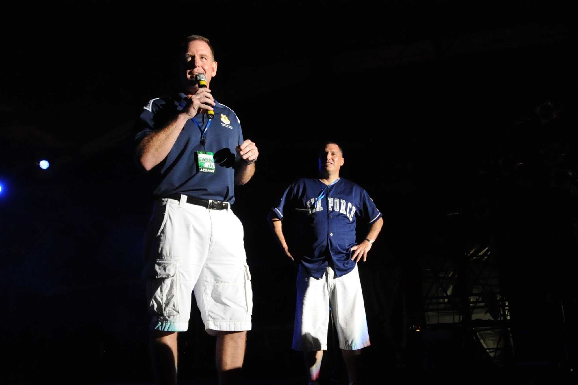 Brig. Gen. James B. Hecker, 18th Wing commander, and Chief Master Sgt Daniel P. McGuire, 18th Wing command chief, give an introductory speech for the 3 Doors Down concert. AmericaFest was an Independence Day celebration showcasing various Japanese and U.S. military aircraft. There were also games, foods, live performances and other entertainment for AmericaFest attendees to enjoy. (U.S. Air Force Photo by Airman 1st Class Zackary A. Henry)