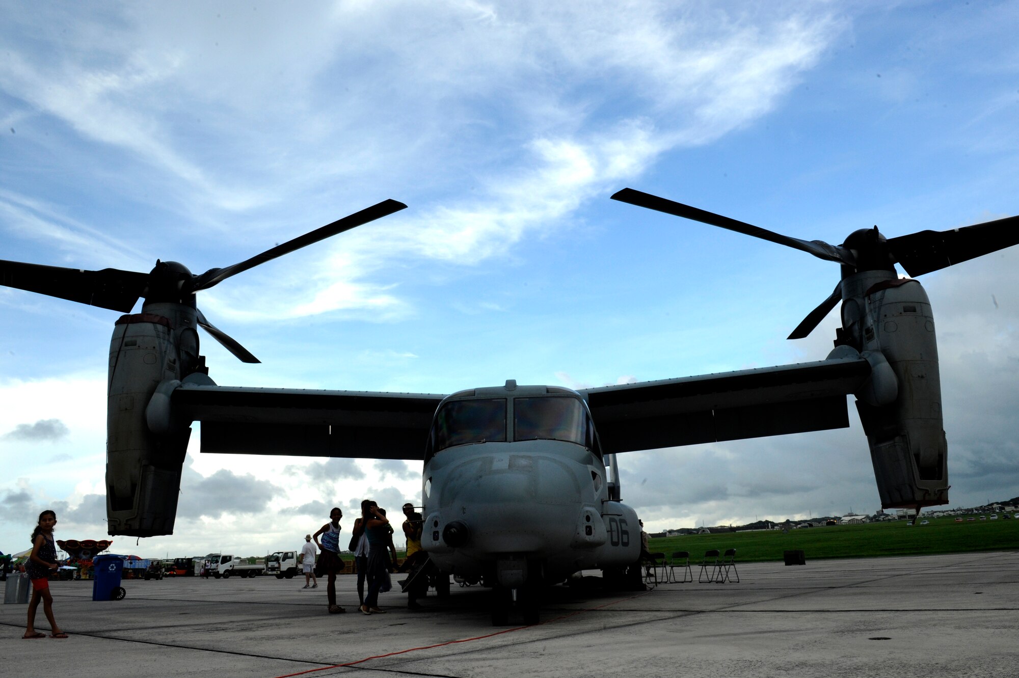 Visitors attending AmericaFest 2014 tour a U.S. Marine Corps MV-22 Osprey during the event on Kadena Air Base, Japan, June 28, 2014. The event included food vendors, games, static aircraft displays a kiddie land for children and performances from numerous groups including American rock band 3 Doors Down. (U.S. Air Force photo by Senior Airman Maeson L. Elleman)