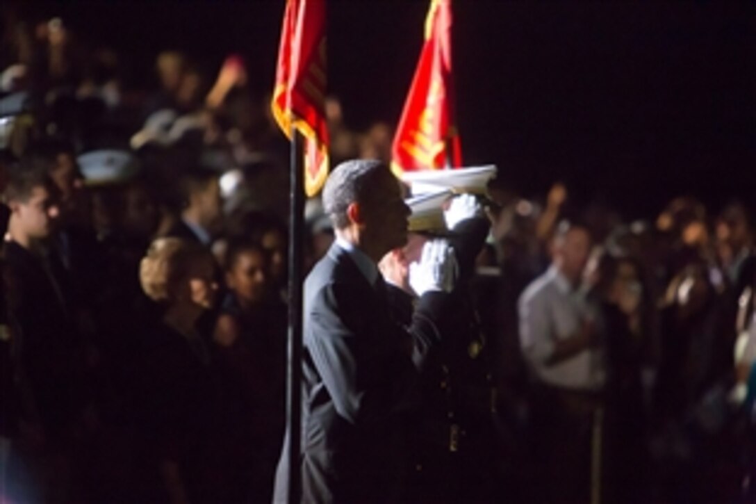 President Barack Obama renders honors during the evening parade at Marine Barracks Washington, D.C., June 27, 2014. The president and First Lady Michelle Obama joined Marine Corps Commandant Gen. James F. Amos and his wife, Bonnie, for the performance, which featured the "Commandant's Own" U.S. Marine Drum and Bugle Corps.