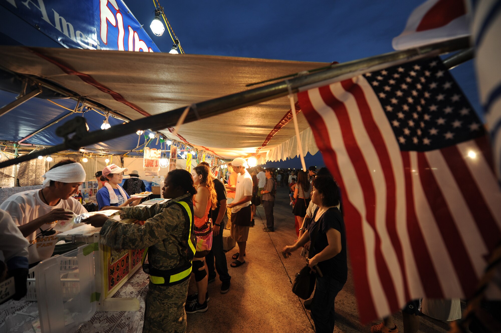 Thousands of festival goers enjoy the 38th Annual AmericaFest celebrating U.S. Independence Day on Kadena Air Base, Japan, June 29, 2014. AmericaFest is an Independence Day celebration showcasing various Japanese and U.S. military aircraft. There were also games, food, live performances and other entertainment for AmericaFest attendees to enjoy. (U.S. Air Force Photo by Airman 1st Class Stephen G. Eigel)