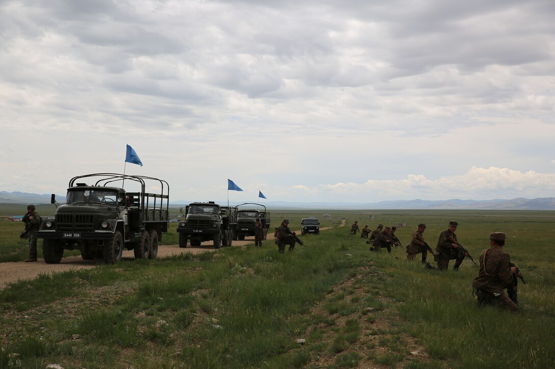 Mongolian Armed Forces members and U.S. Marines and sailors provide security for a simulated improvised explosive device drill June 23 at Five Hills Training Area, Mongolia, during convoy operations training at Exercise Khaan Quest 2014. KQ14 is a regularly scheduled, multinational exercise hosted annually by Mongolian Armed Forces and co-sponsored this year by U.S. Army, Pacific and U.S. Marine Corps Forces, Pacific. KQ14 is the latest in a continuing series of exercises designed to promote regional peace and security. This year marks the 12th iteration of this training event. During the training, the service members searched for simulated improvised explosive devices and then practiced what they would do in a real-world situation. The Marines and sailors are with Company C, 1st Battalion, 8th Marine Regiment, which is currently assigned to 4th Marine Regiment, 3rd Marine Division, III Marine Expeditionary Force, under the unit deployment program. (U.S. Marine Corps photo by Cpl. Alyssa N. Gunton)