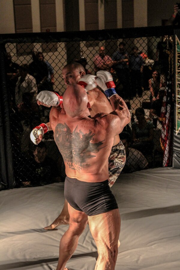 Master Sgt. Donald W. Johnson, a low altitude air defense gunner with Marine Air Control Group 28, attached to Marine Medium Tiltrotor Squadron 365 (Reinforced), 24th Marine Expeditionary Unit, and native of Rush City, Minn., lands a punch on his opponent’s head during a mixed martial arts fight in Havelock, N.C., June 21, 2014. Johnson won by knockout in 48 seconds and advanced his record to 2-0. He is scheduled to deploy with the 24th MEU at the end of the year. (U.S. Marine Corps by Lance Cpl. Austin A. Lewis)