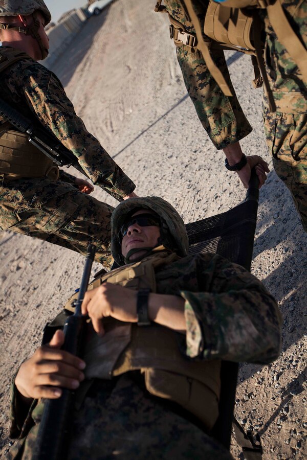 U.S. 5TH FLEET AREA OF RESPONSIBILITY (June 27, 2014) U.S. Marines with the 22nd Marine Expeditionary Unit (MEU) carry a simulated casualty during a physical conditioning drill as part of martial arts training. The Marines are conducting previously scheduled sustainment training to maintain proficiency and a high degree of readiness. The 22nd MEU is deployed with the Bataan Amphibious Ready Group as a theater reserve and crisis response force throughout U.S. Central Command and the U.S. 5th Fleet area of responsibility. (U.S. Marine Corps photo by Sgt. Austin Hazard/Released)