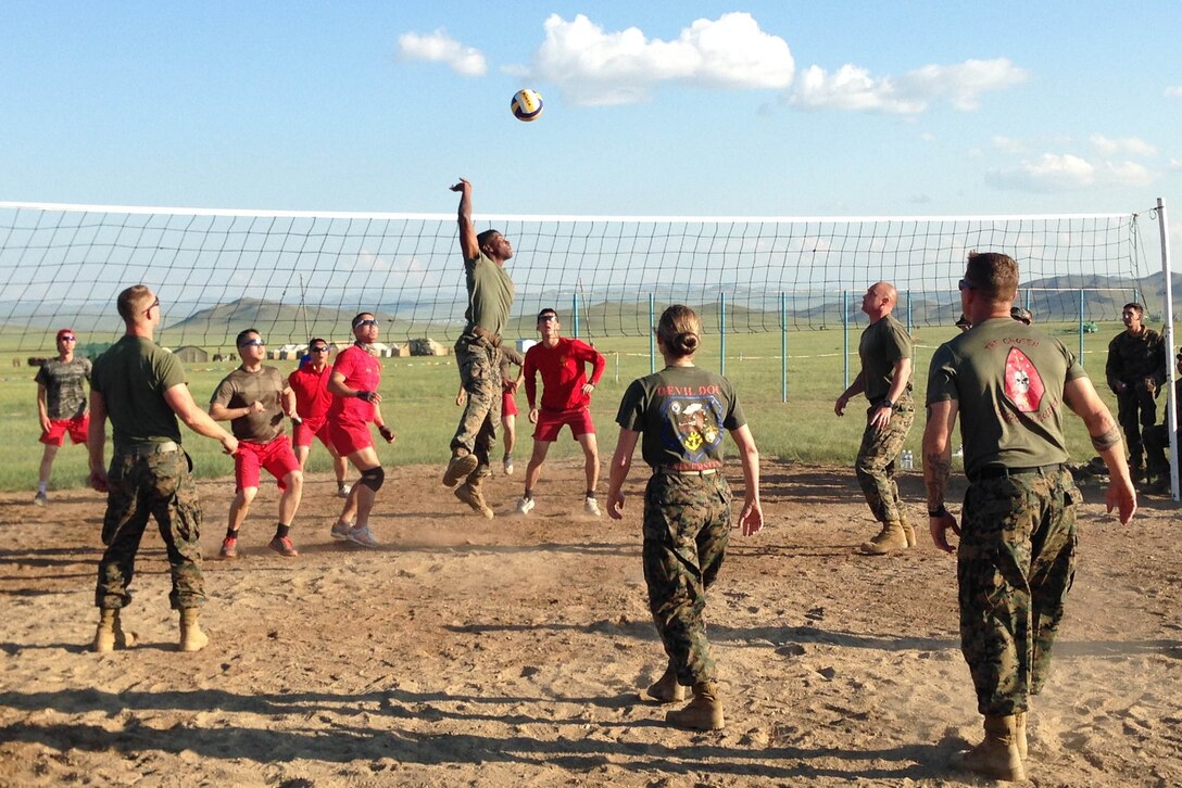 Republic of Korea Marines and U.S. Marines and a sailor play a game of volleyball the evening of June 25 at Five Hills Training Area, Mongolia, during Khaan Quest 2014. KQ14 is a regularly scheduled, multinational exercise hosted annually by Mongolian Armed Forces and co-sponsored this year by U.S. Army, Pacific, and U.S. Marine Corps Forces, Pacific. KQ14 is the latest in a continuing series of exercises designed to promote regional peace and security. This year marks the 12th iteration of this training event. The Marines are infantrymen with Company C, 1st Battalion, 8th Marine Regiment, which is currently assigned to 4th Marine Regiment, 3rd Marine Division, III Marine Expeditionary Force, under the unit deployment program. The sailor is a doctor with 3rd Medical Battalion, 3rd Marine Logistics Group, III MEF.