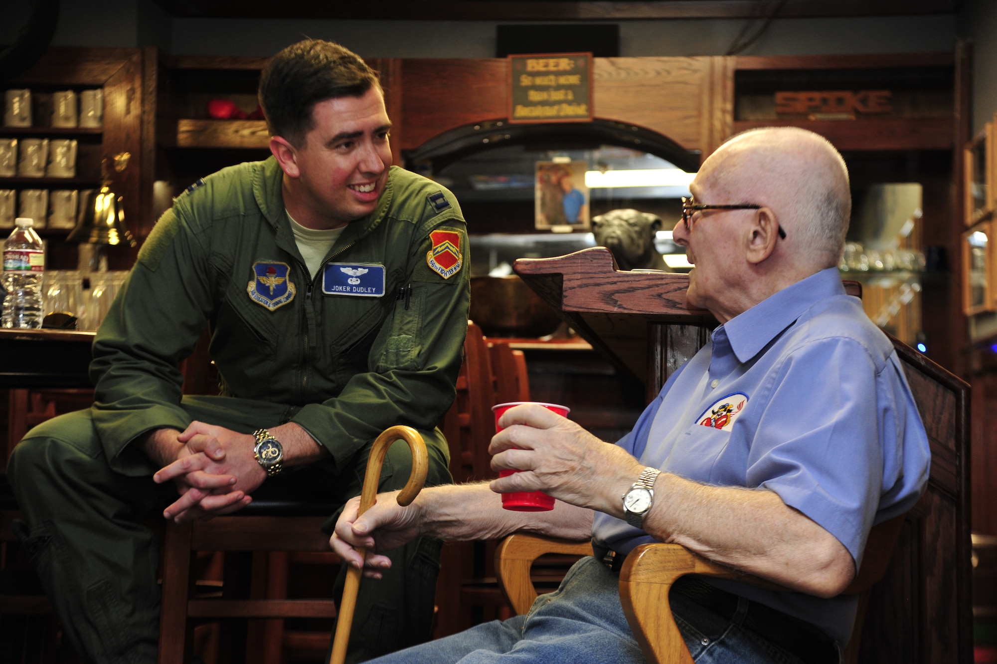 Capt. Brian Dudley, left, chats with retired Navy officer Anthony Canzonetta, a Korean War pilot, June 13, 2014, in the 62nd Fighter Squadron's heritage room on Luke Air Force Base, Ariz. During their time together, Dudley and Canzonetta talked about topics ranging from flying, Canzonetta’s love for fast cars, his experience recovering from injuries, and transitioning to civilian life. The tour was planned for Canzonetta’s 83rd birthday. Dudley is the 62nd FS's A-Flight commander and an instructor pilot. (U.S. Air Force photo/Senior Airman Grace Lee)